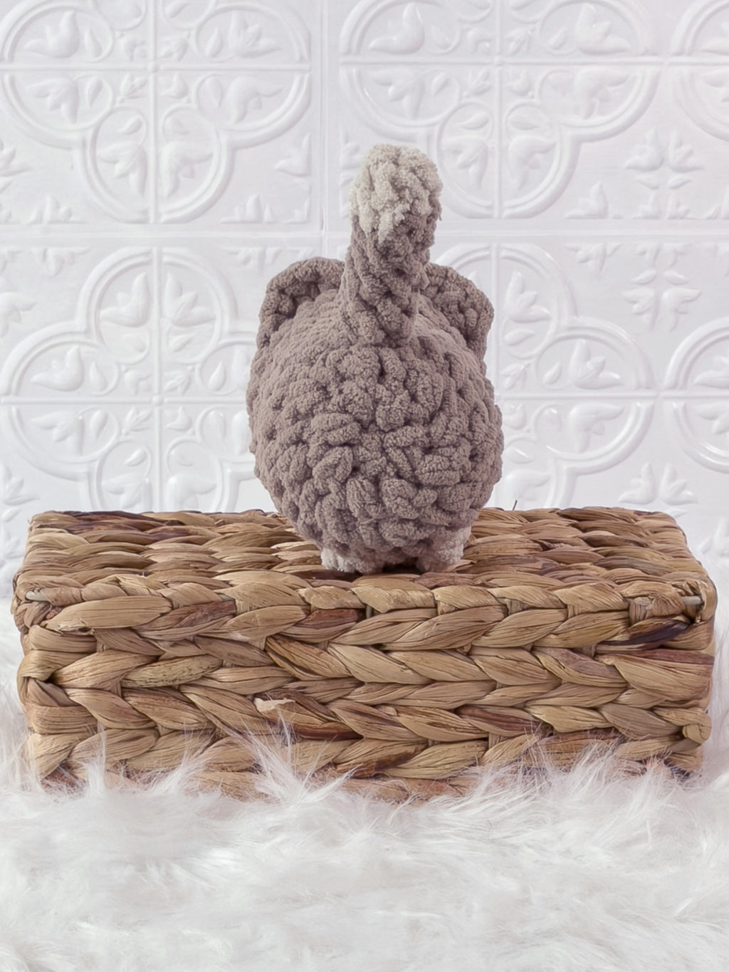 Handmade beige loaf cat crochet plushie shown from the back