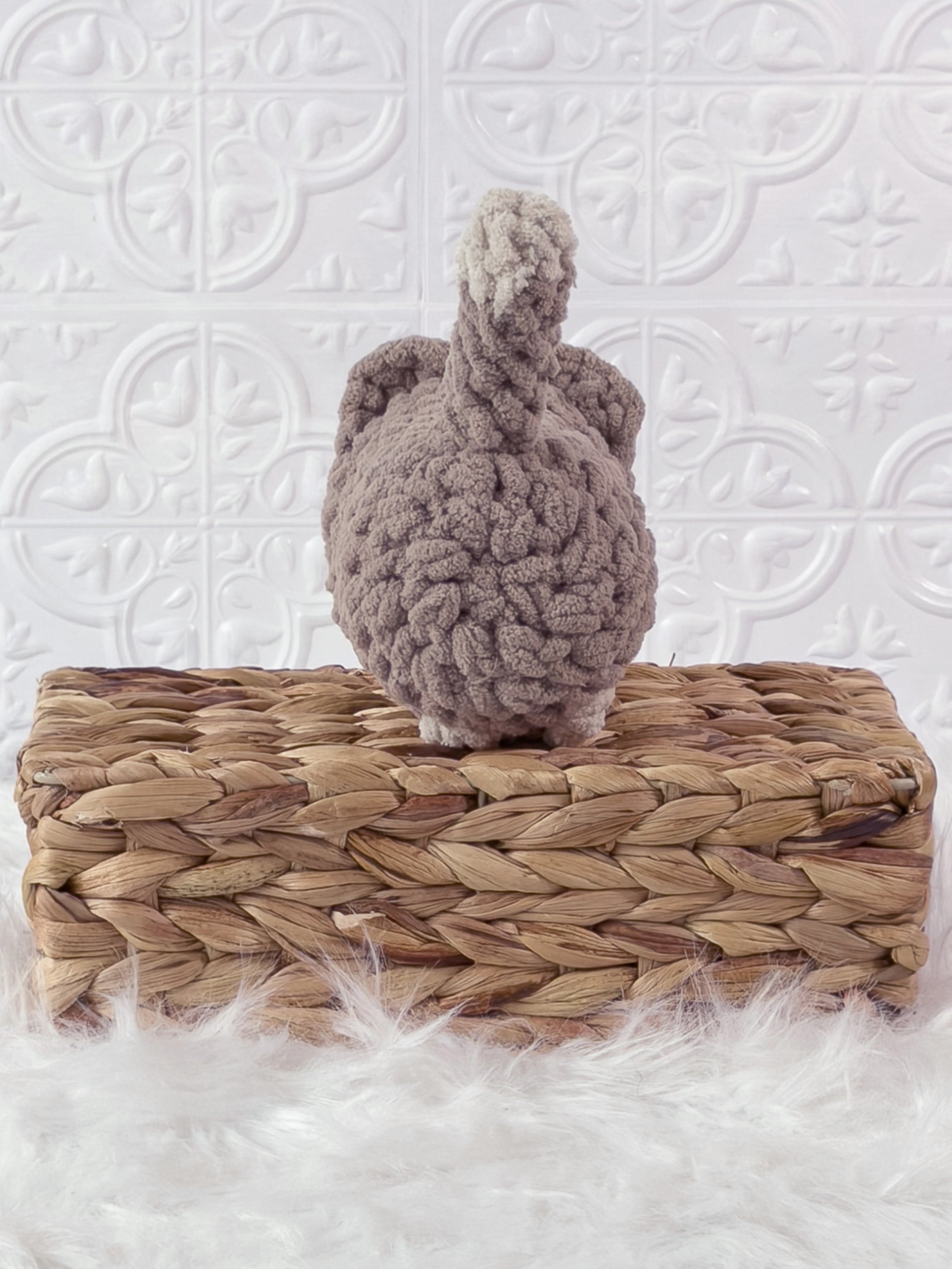Handmade beige loaf cat crochet plushie shown from the back
