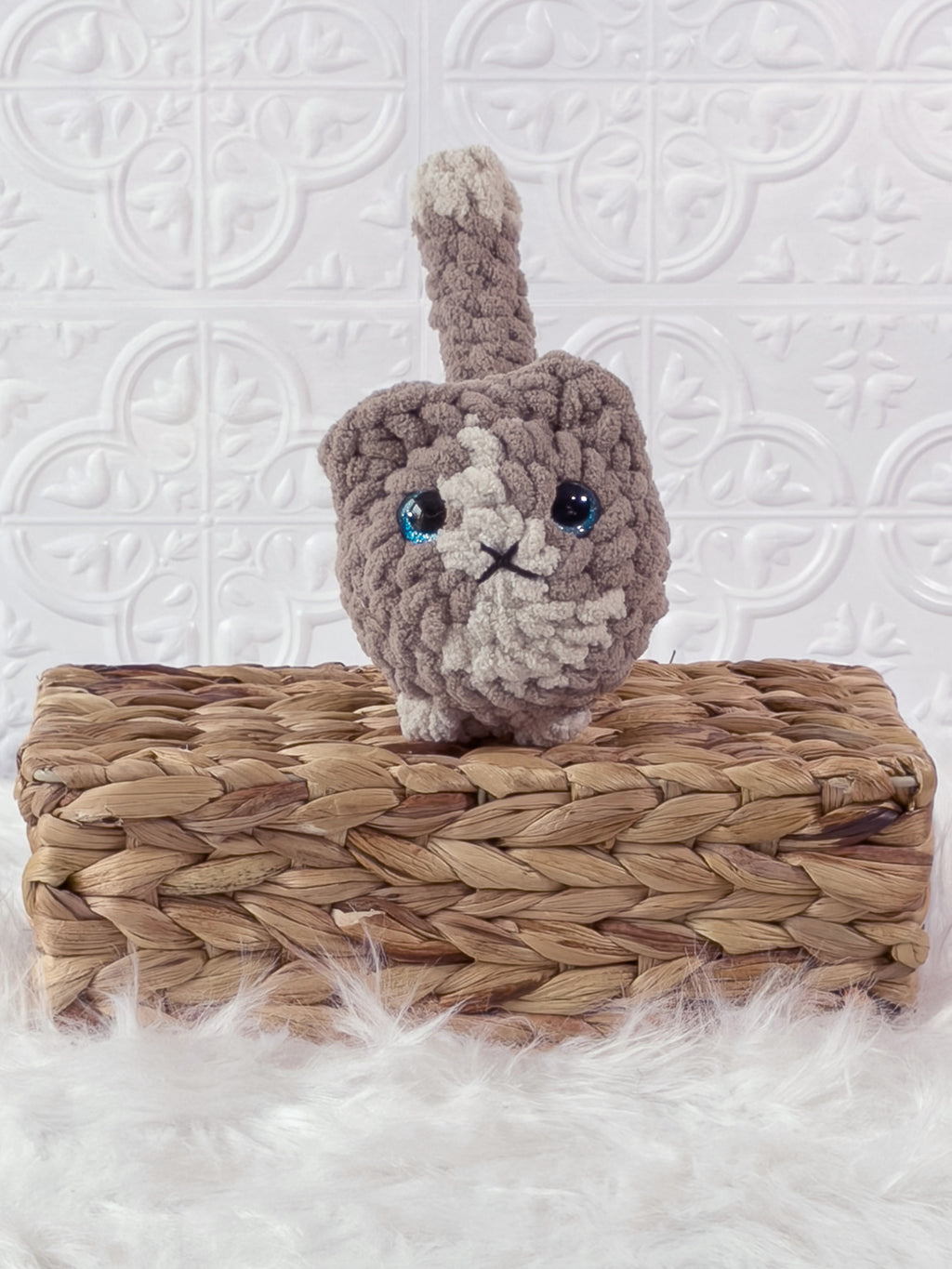 Handmade beige loaf cat crochet plushie shown from the front