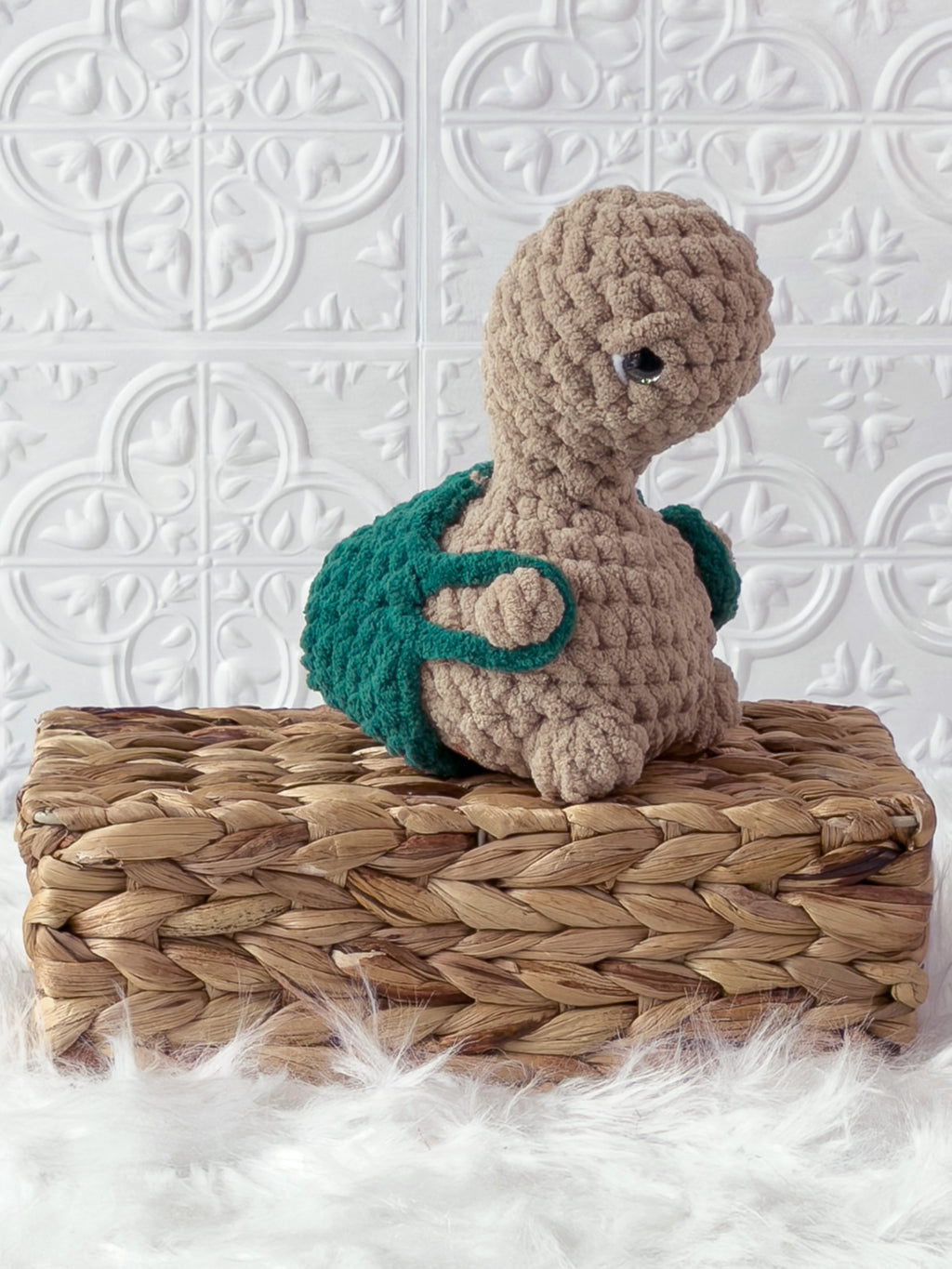 Handmade beige, dark turtle crochet plushie shown from an angled view
