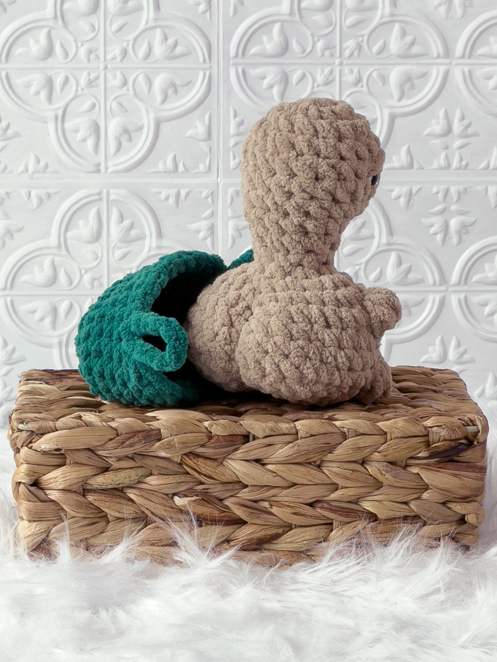 Handmade beige, dark turtle crochet plushie shown from the back
