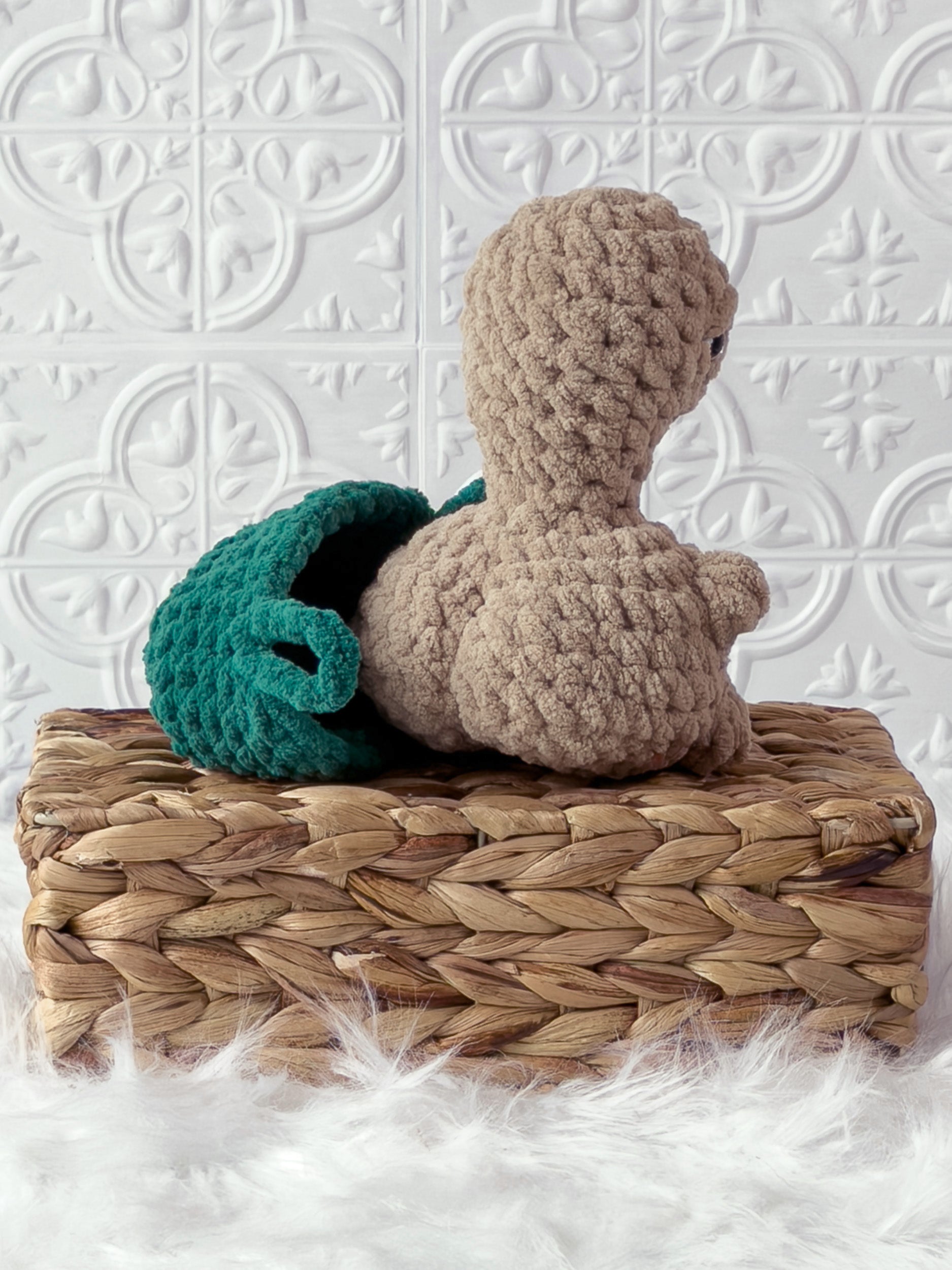 Handmade beige, dark turtle crochet plushie shown from the back