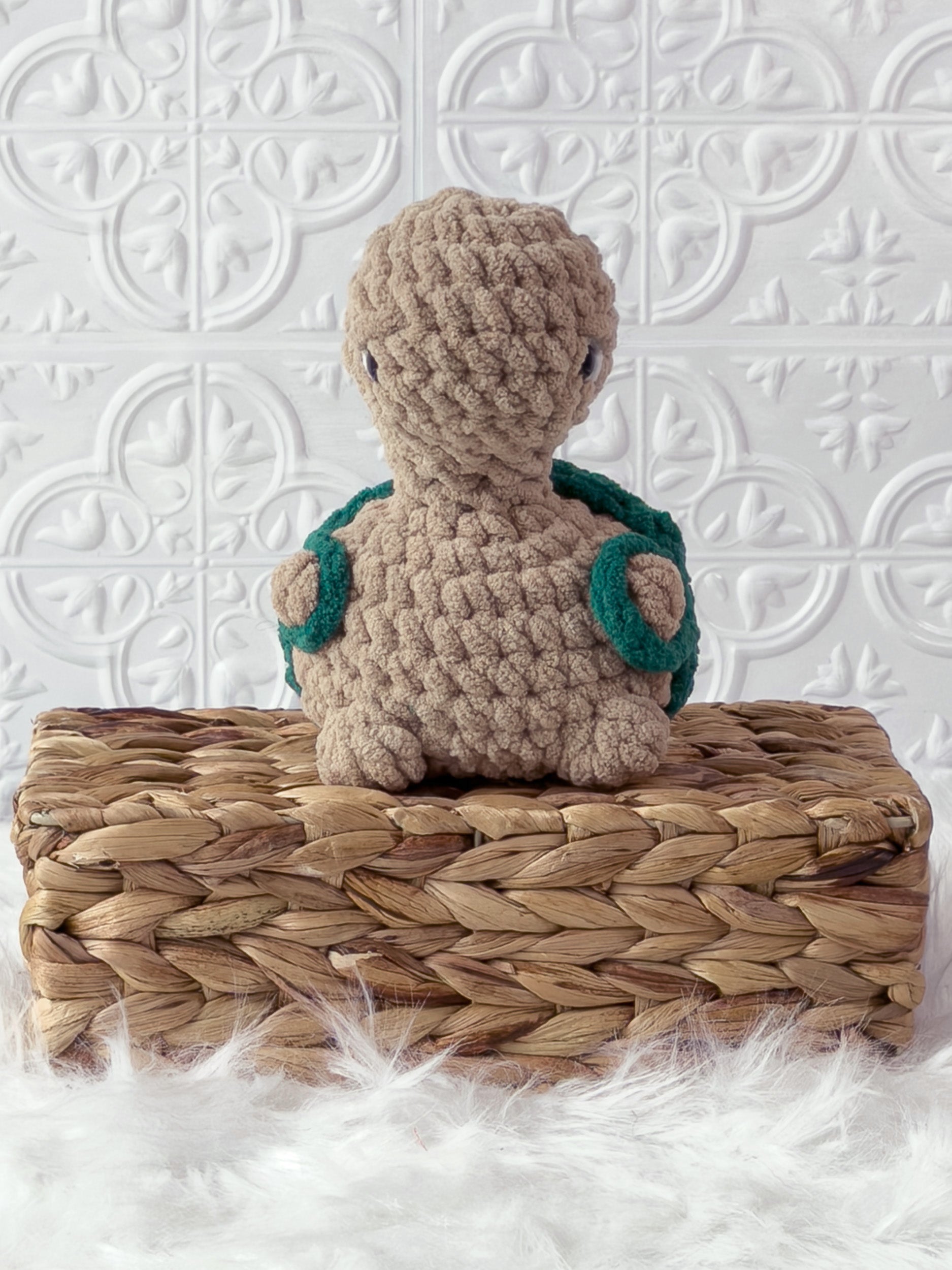 Handmade beige, dark turtle crochet plushie shown from the front