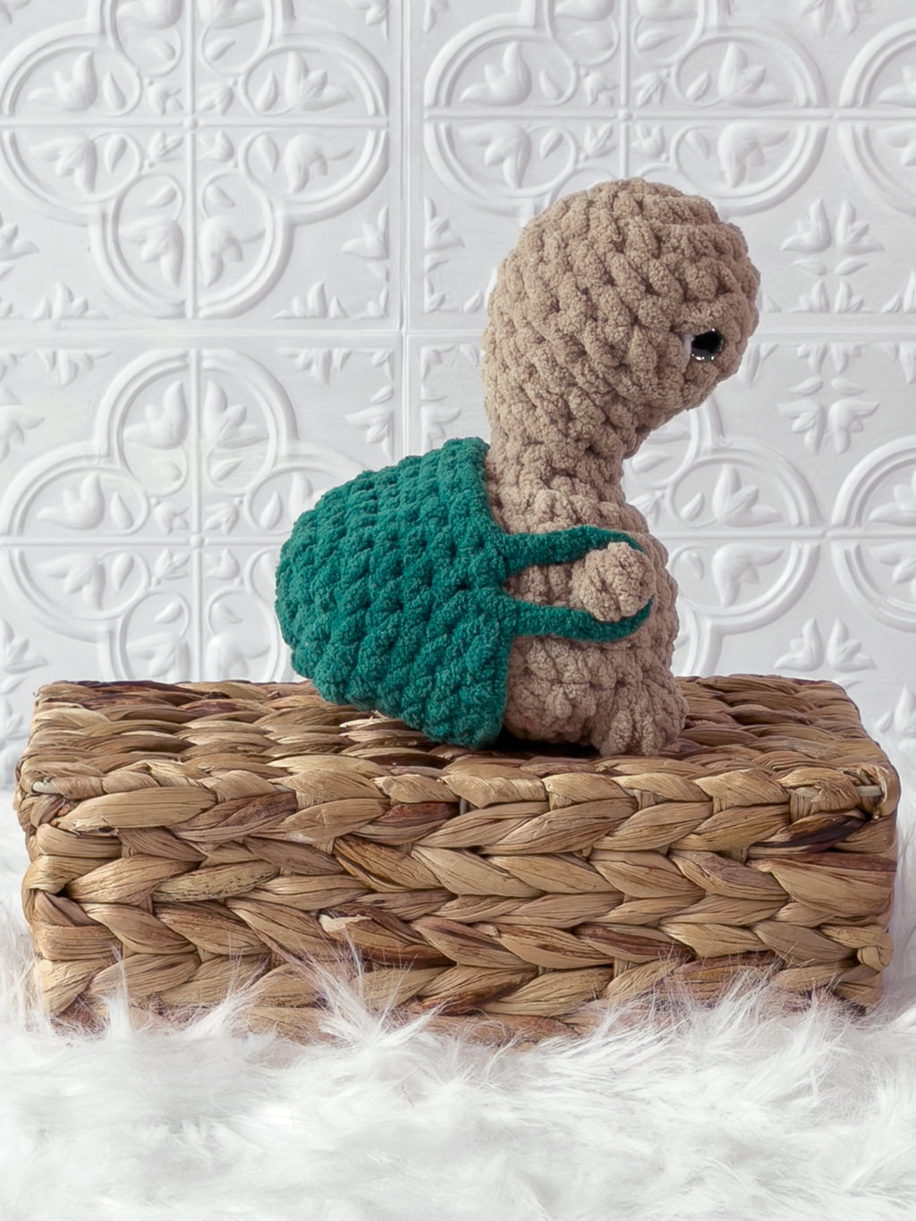 Handmade beige, dark turtle crochet plushie shown from the side