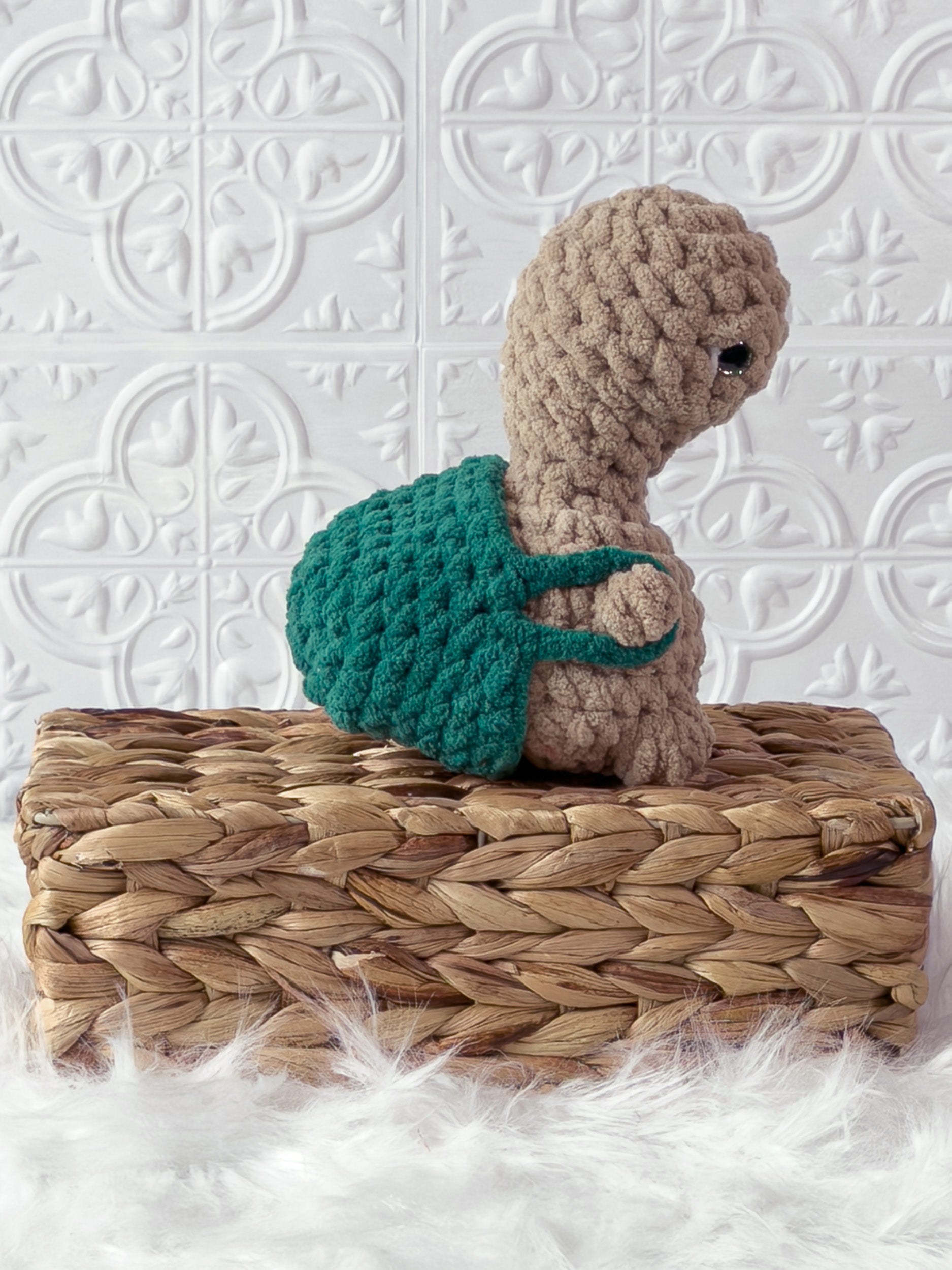 Handmade beige, dark turtle crochet plushie shown from the side