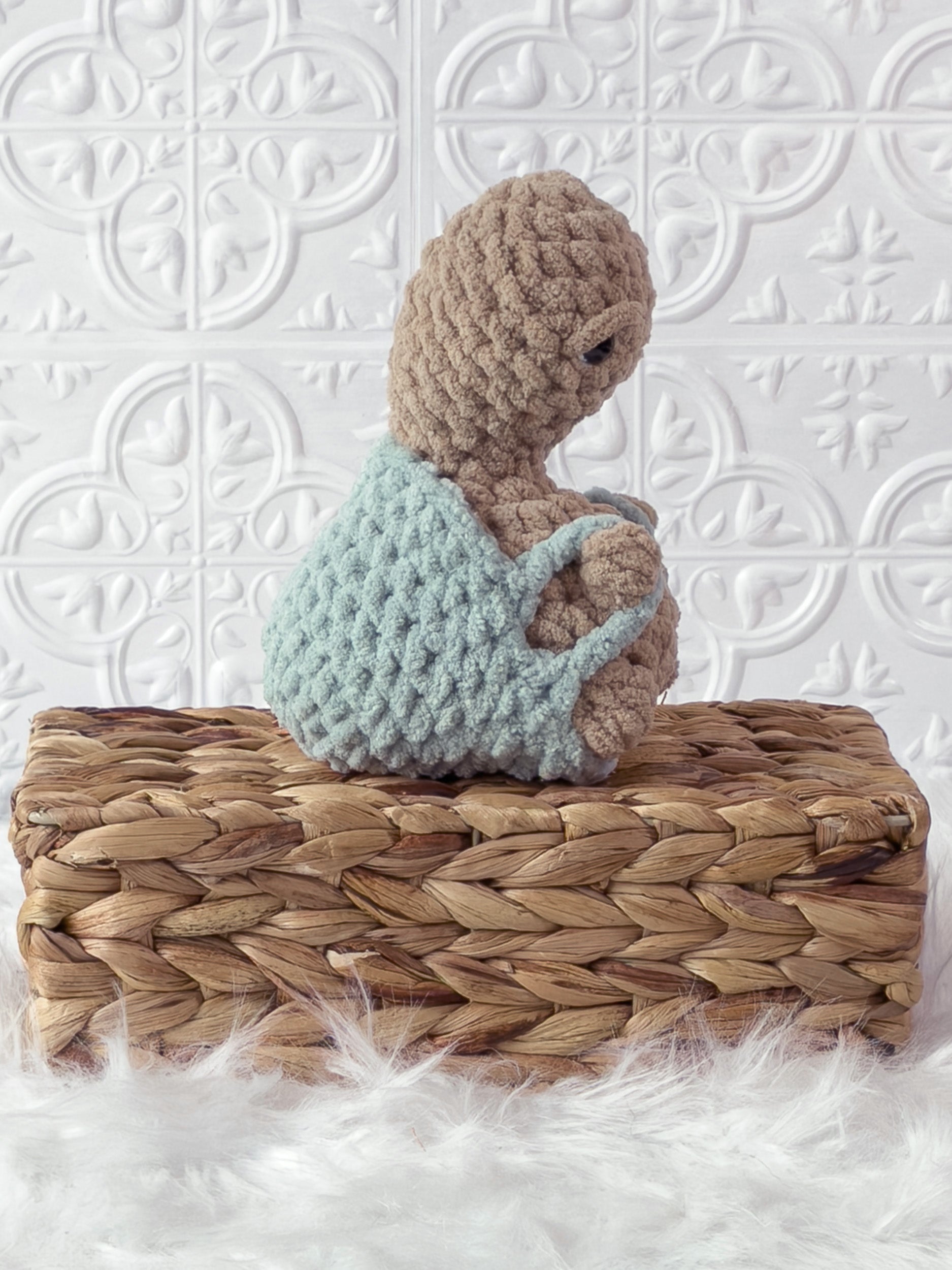 Handmade beige, light turtle crochet plushie shown from the side