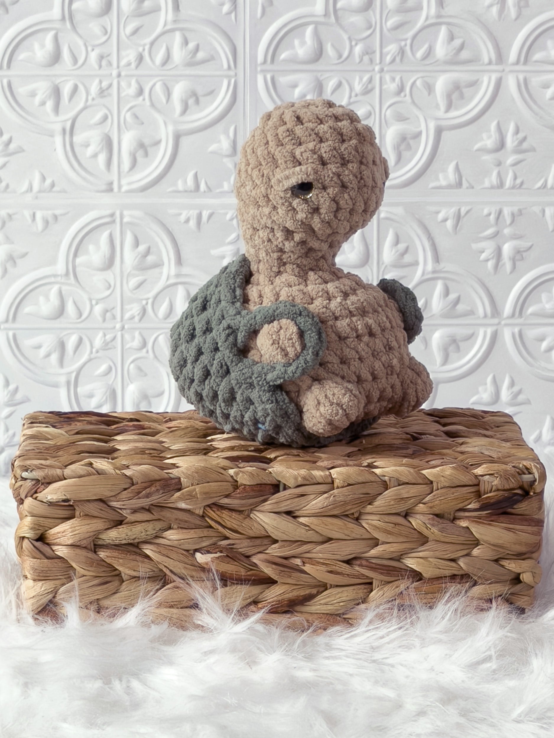 Handmade beige, medium turtle crochet plushie shown from an angled view