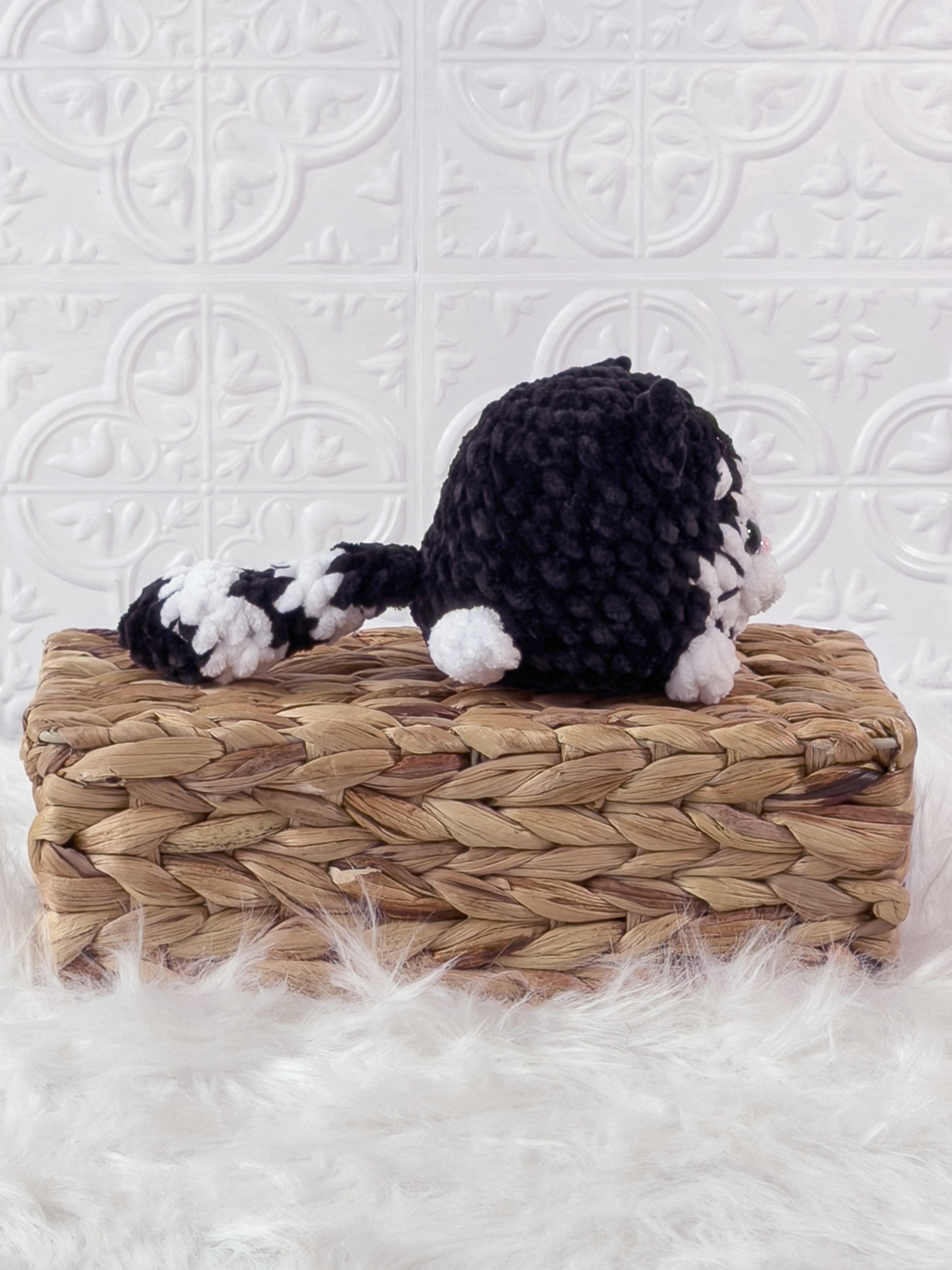 Handmade black kitten crochet plushie shown from the side