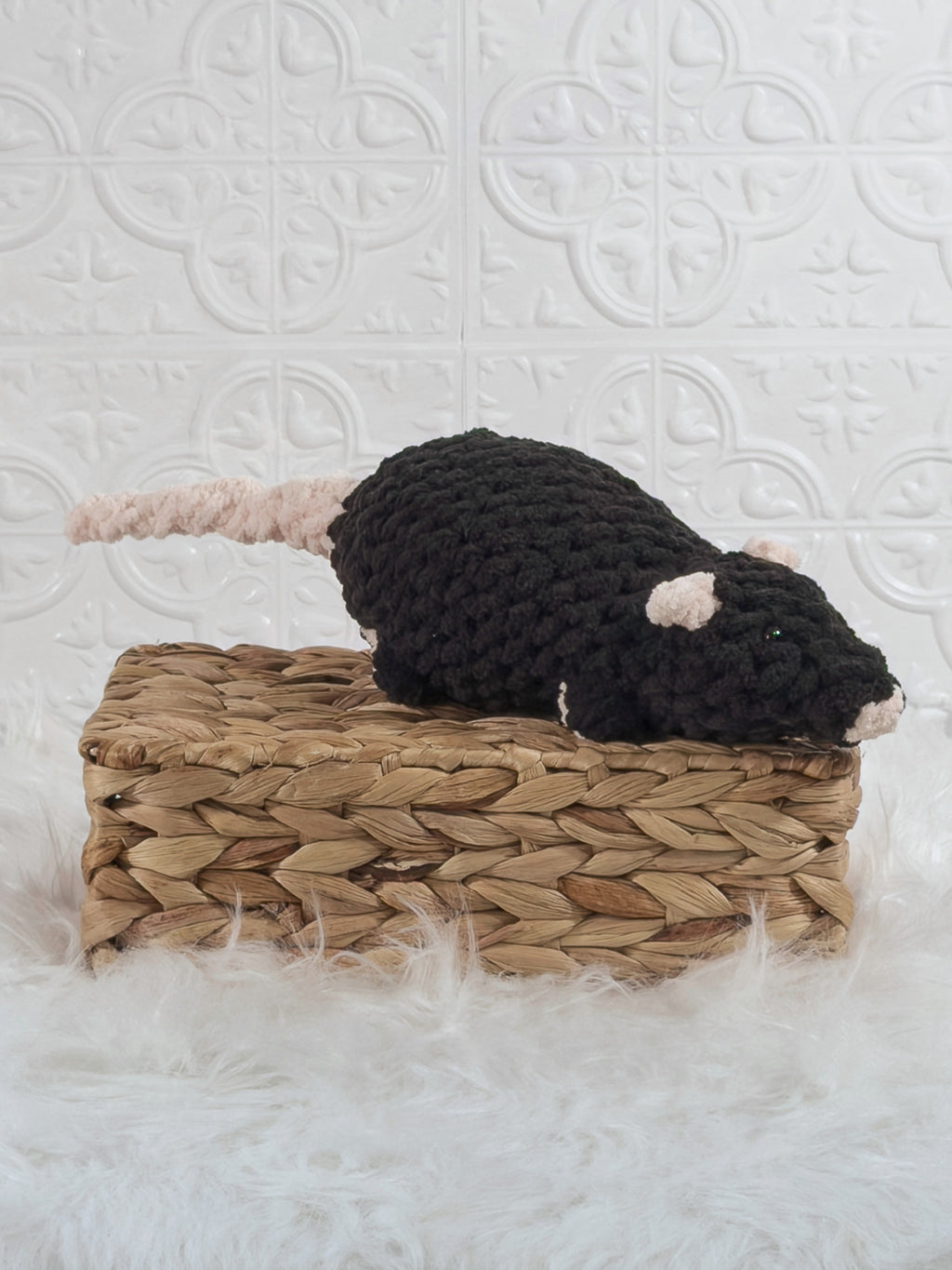 Handmade black rat crochet plushie shown from an angled view