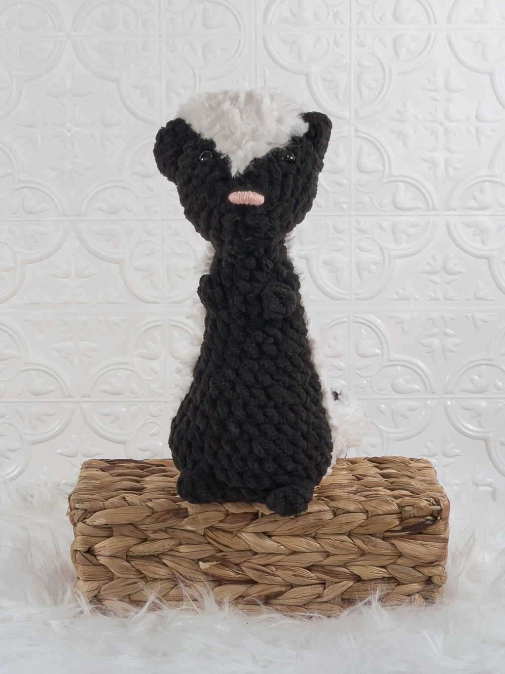 Handmade black skunk crochet plushie shown from the front
