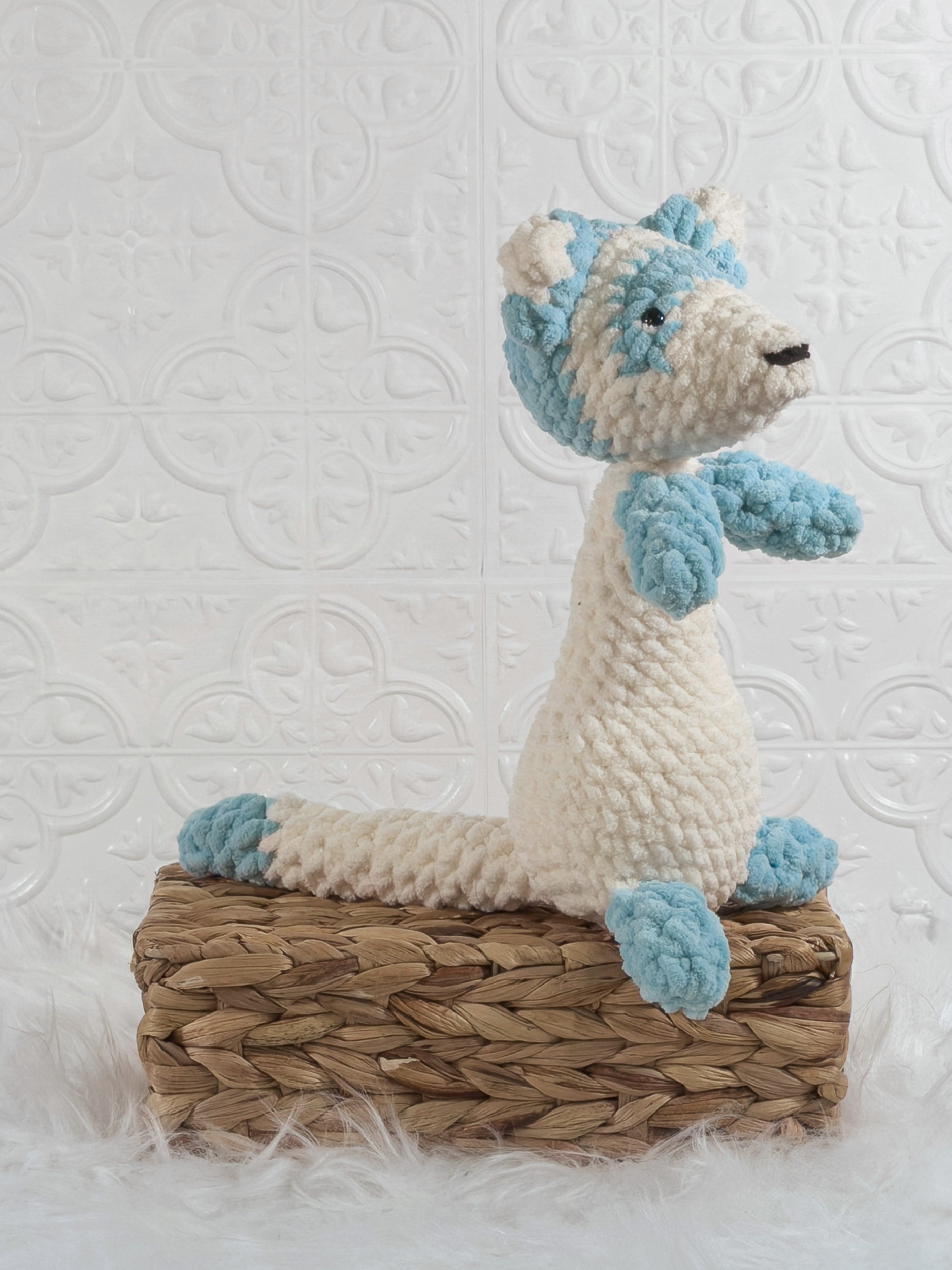 Handmade blue ferret crochet plushie shown from an angled view