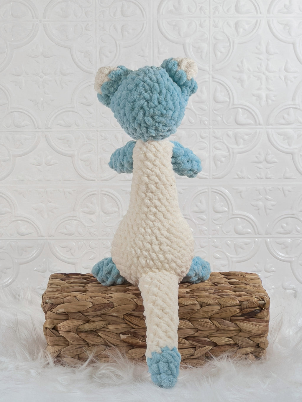 Handmade blue ferret crochet plushie shown from the back