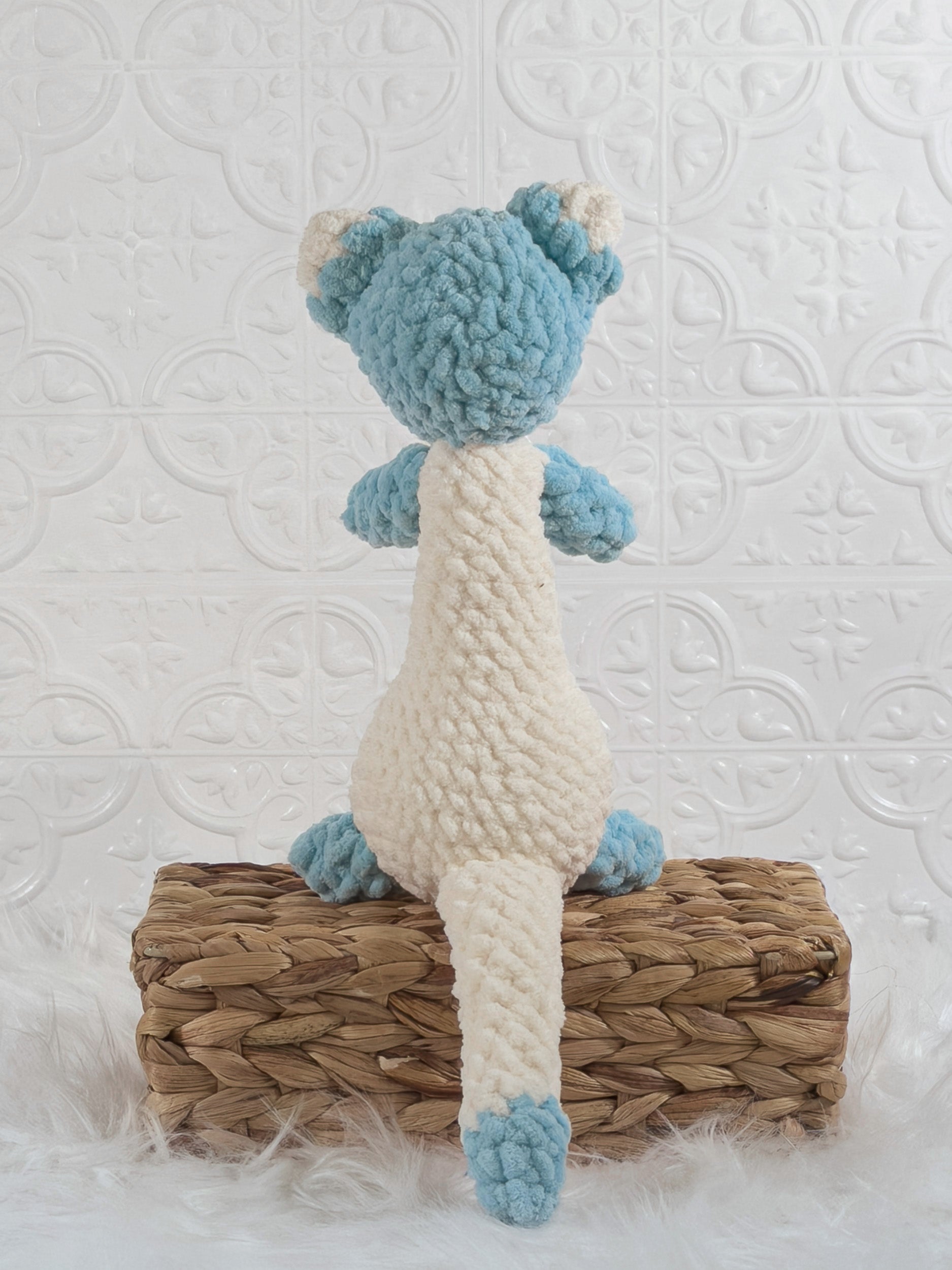 Handmade blue ferret crochet plushie shown from the back