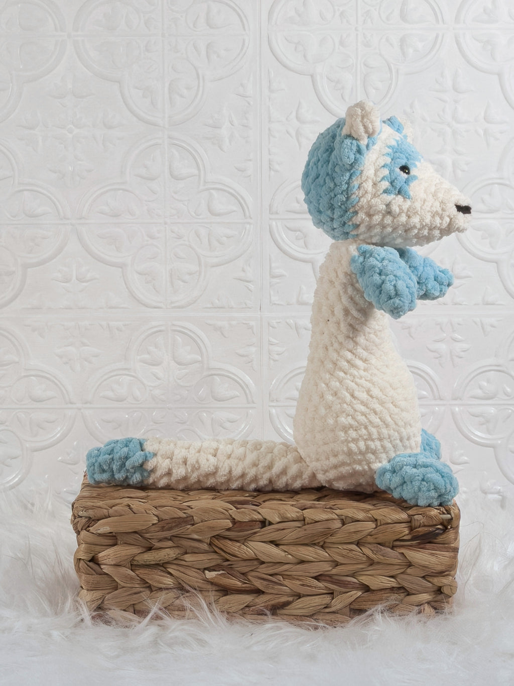 Handmade blue ferret crochet plushie shown from the side