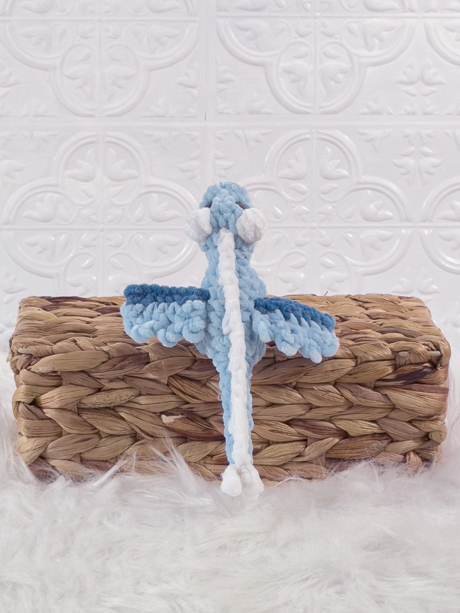 Handmade blue mini dragon crochet plushie shown from the back