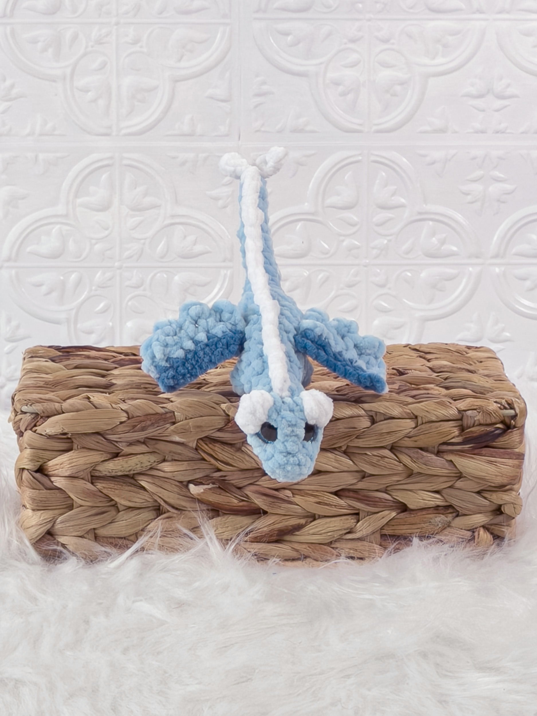 Small handmade dragon crochet plushie shown from the front