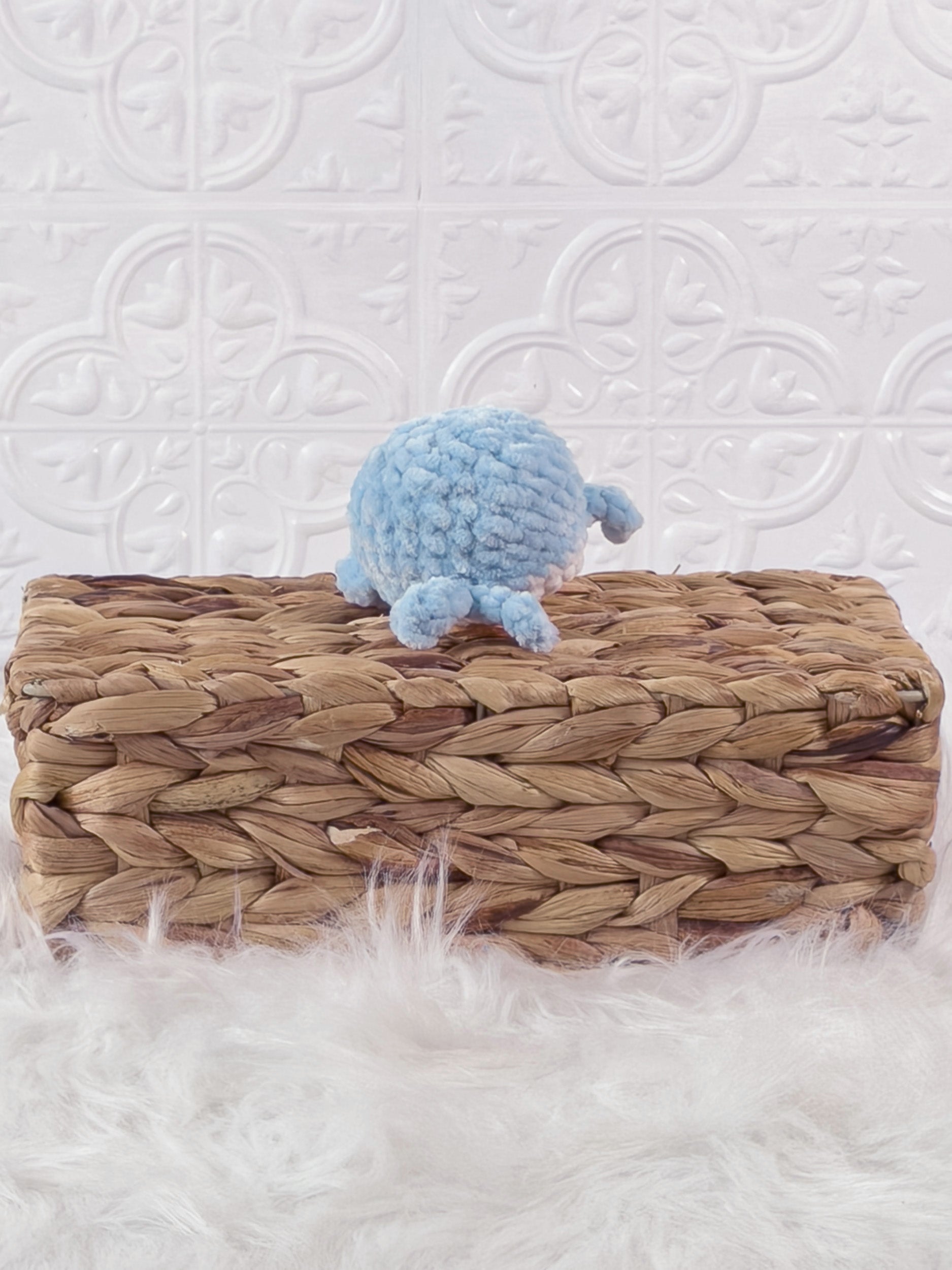 Small handmade whale crochet plushie shown from the front
