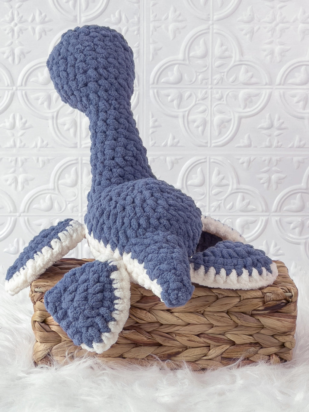 Handmade blue plesiosaurus crochet plushie shown from the back