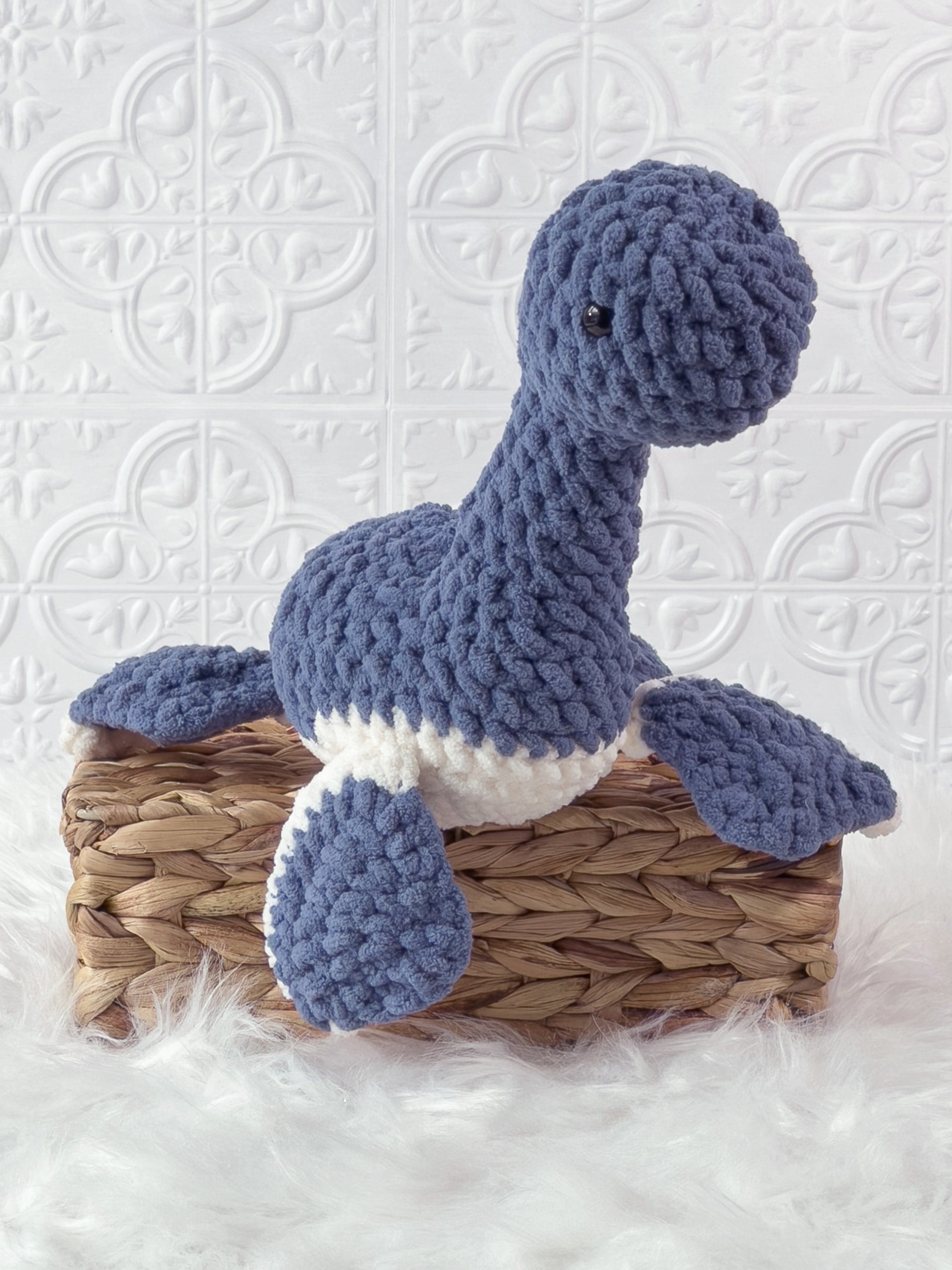 Handmade blue plesiosaurus crochet plushie shown from the front