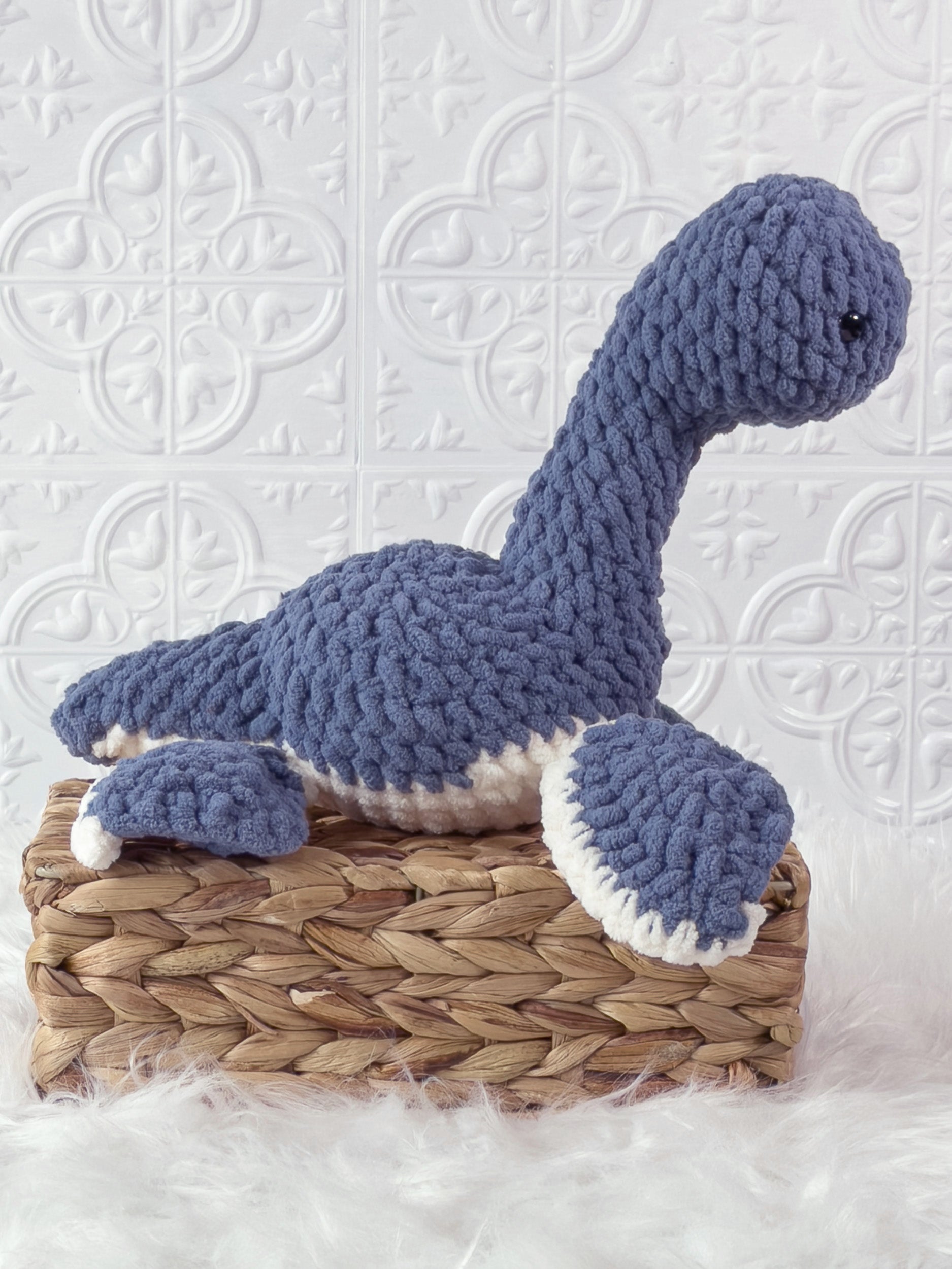 Handmade blue plesiosaurus crochet plushie shown from the side