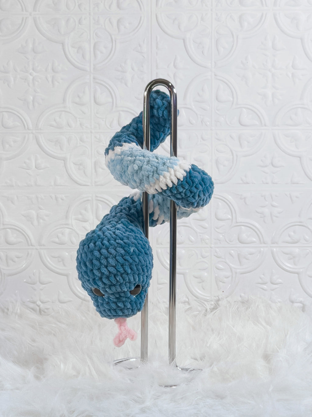 Handmade blue snake crochet plushie shown from the back