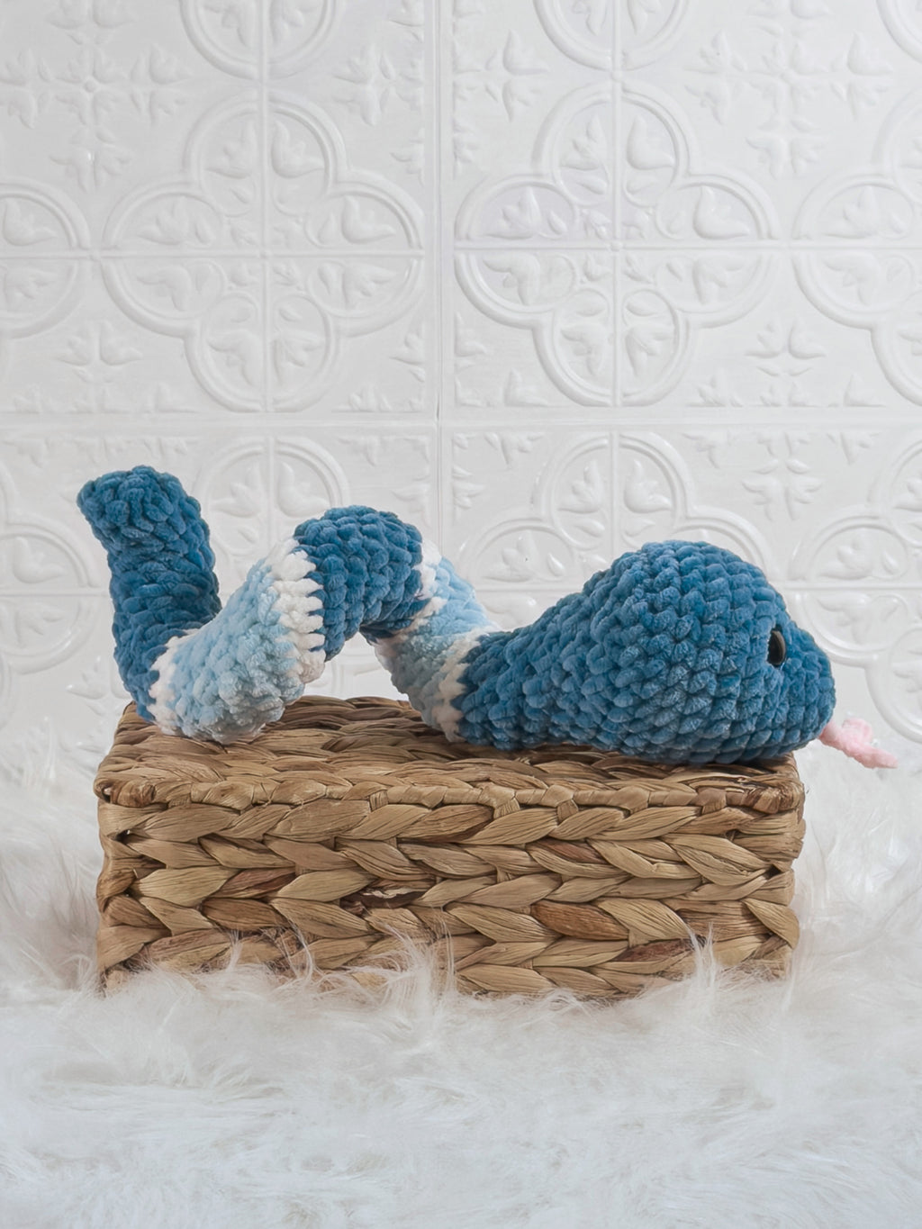 Handmade blue snake crochet plushie shown from the side