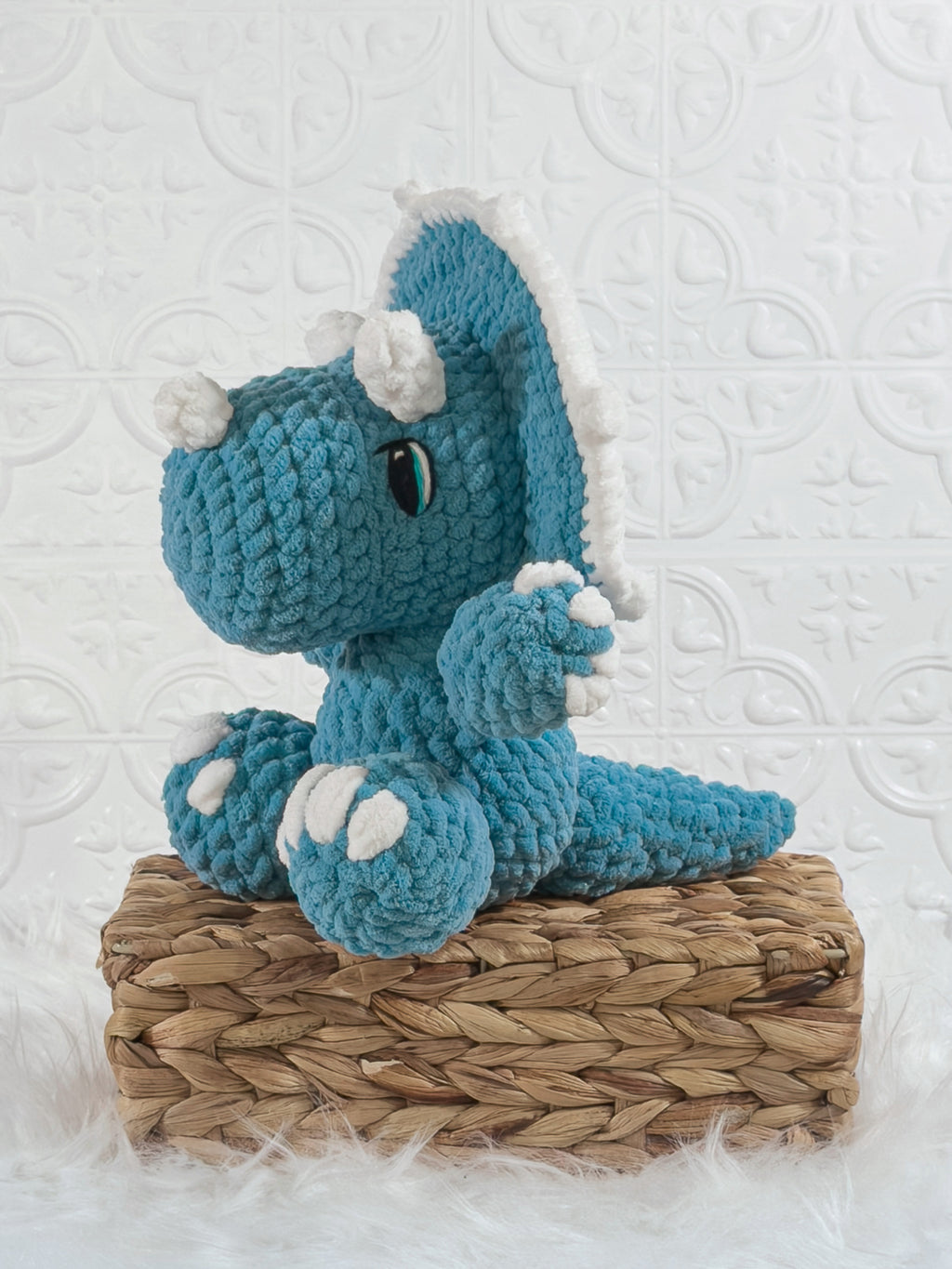 Handmade triceratops crochet plushie shown from the front