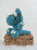 Handmade triceratops crochet plushie shown from the front