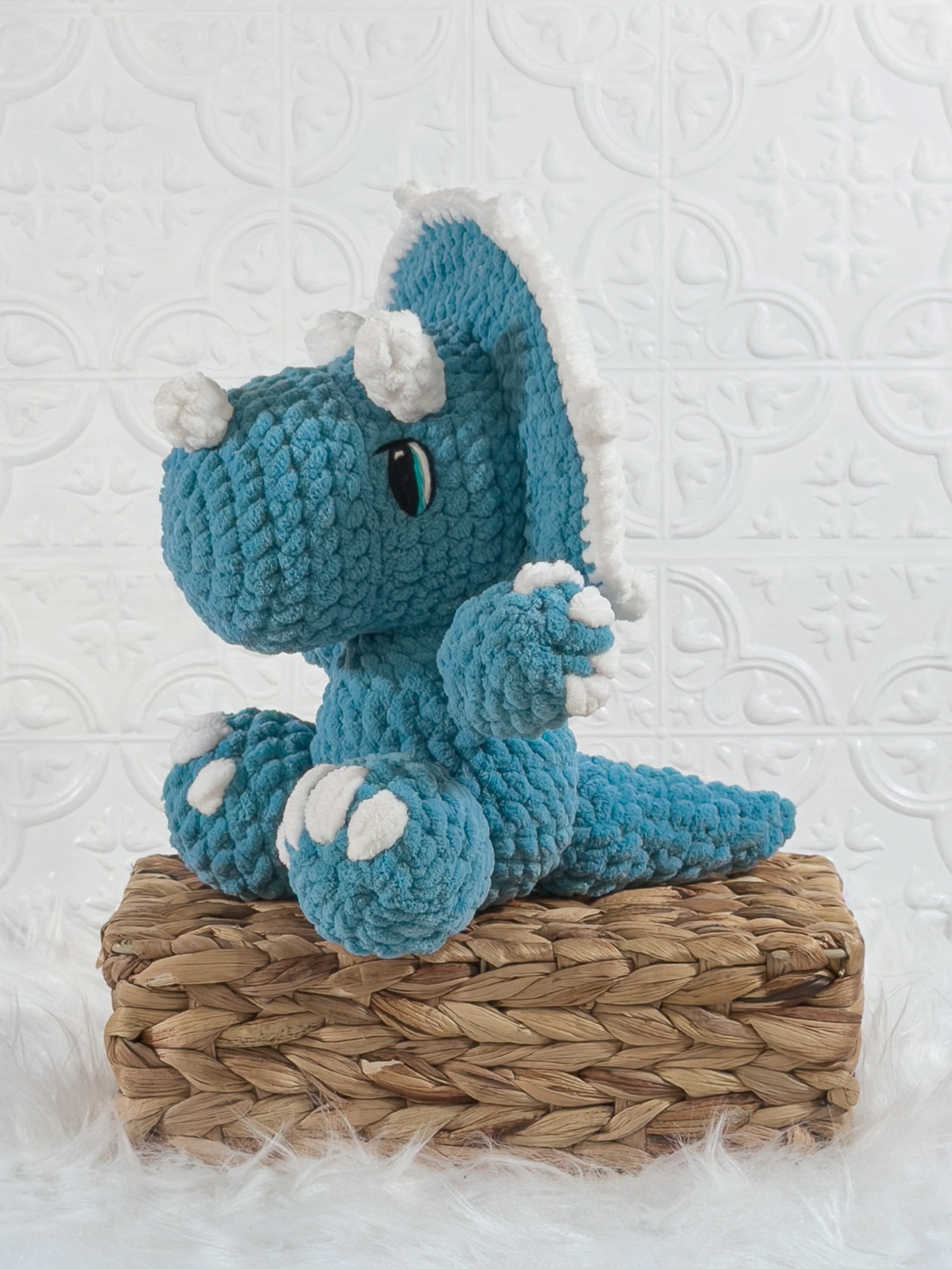 Handmade triceratops crochet plushie shown from the front
