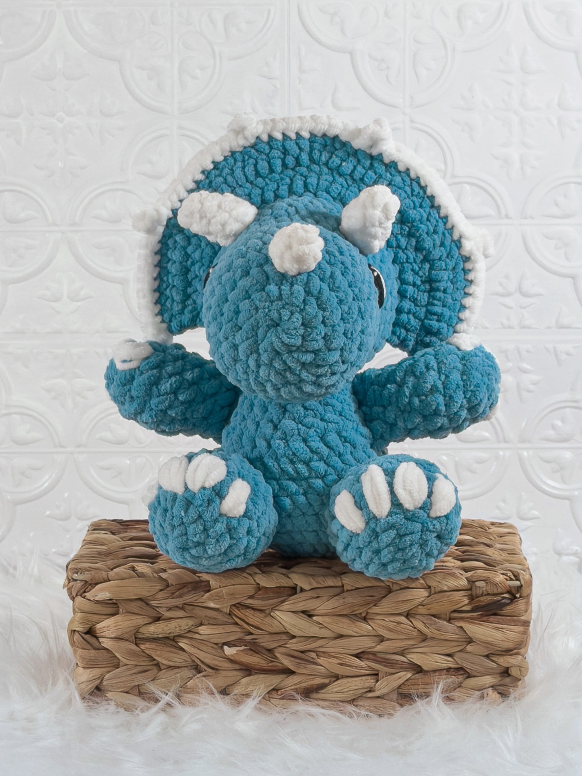 Handmade blue triceratops crochet plushie shown from the front