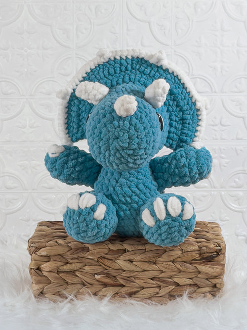 Handmade blue triceratops crochet plushie shown from the front
