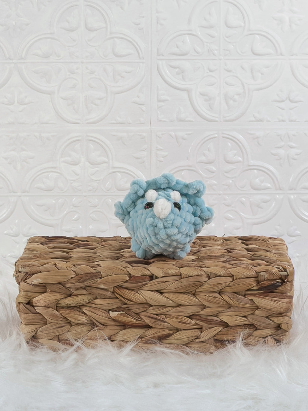 Handmade blue triceratops crochet plushie shown from the front