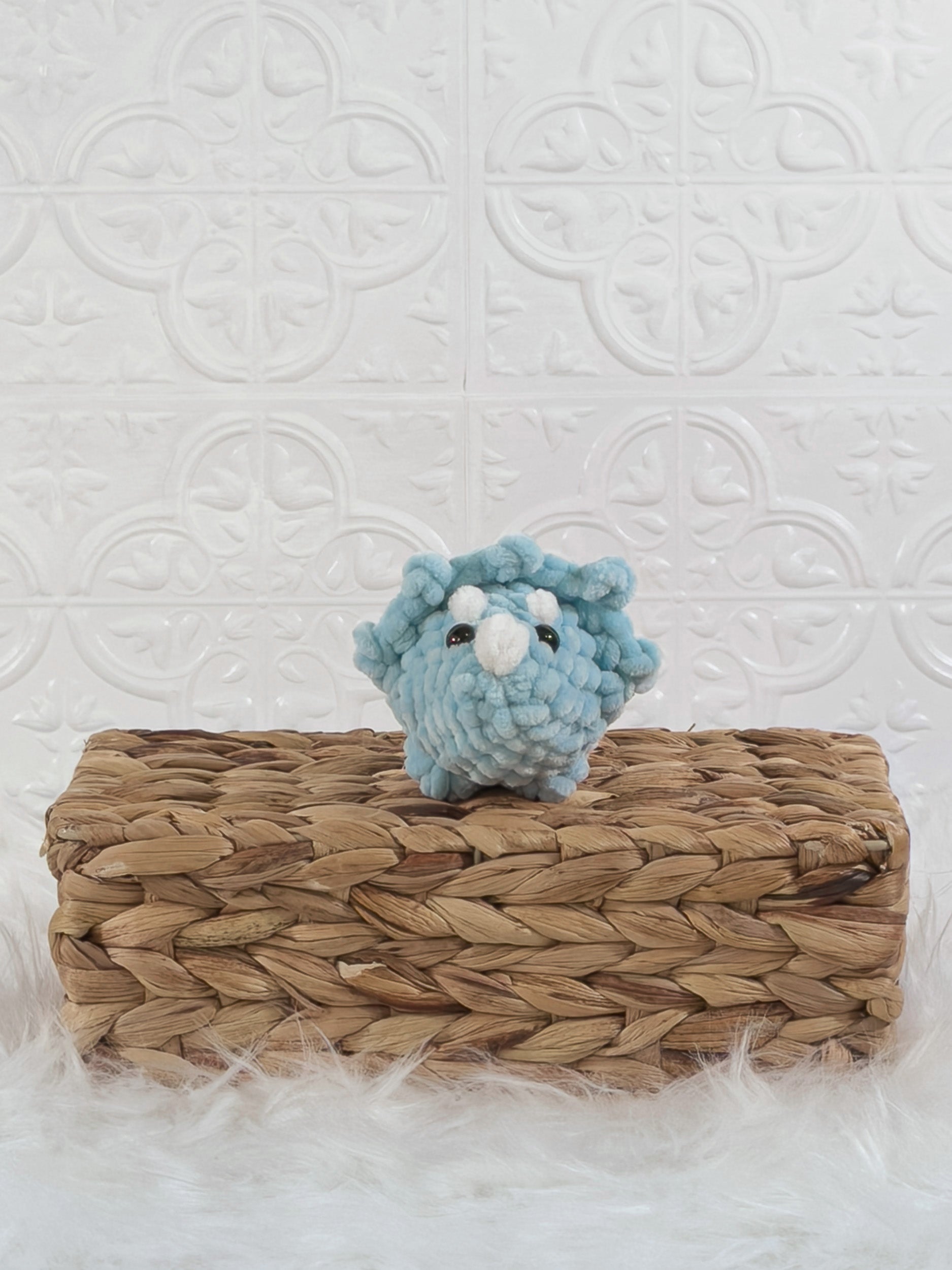 Handmade blue triceratops crochet plushie shown from the front