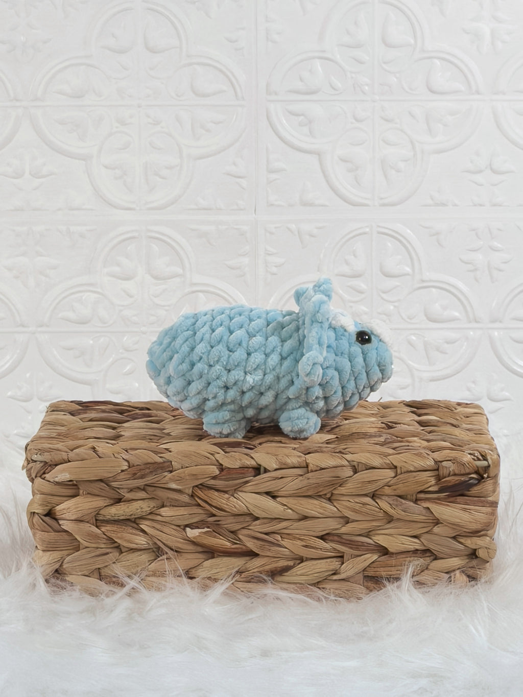 Handmade blue triceratops crochet plushie shown from the side