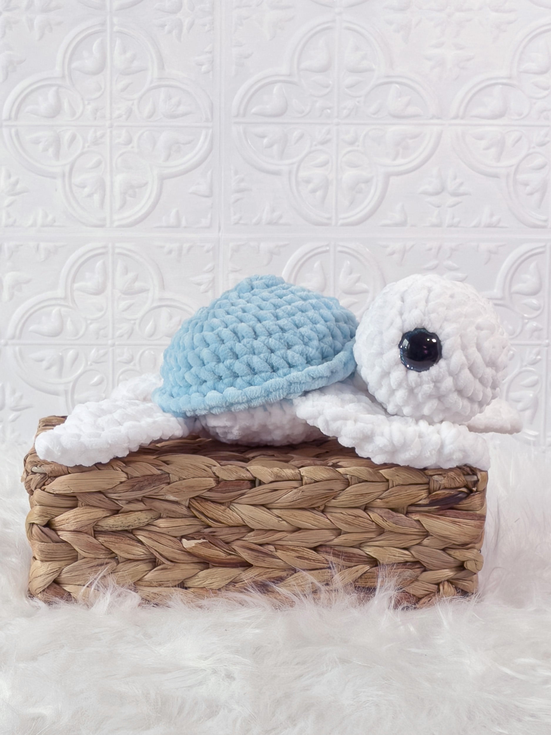 Handmade blue turtle crochet plushie shown from an angled view