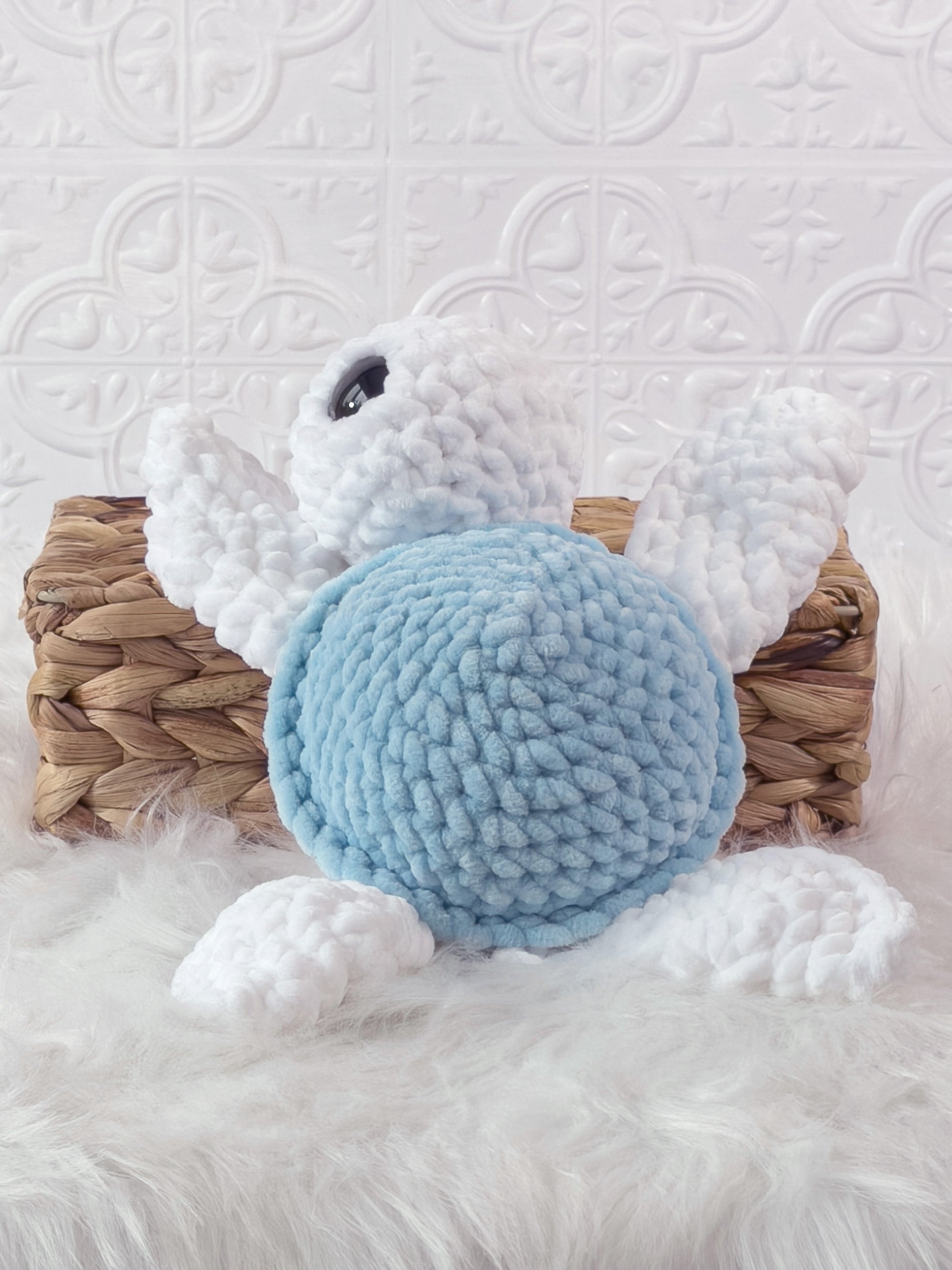 Handmade blue turtle crochet plushie shown from the back