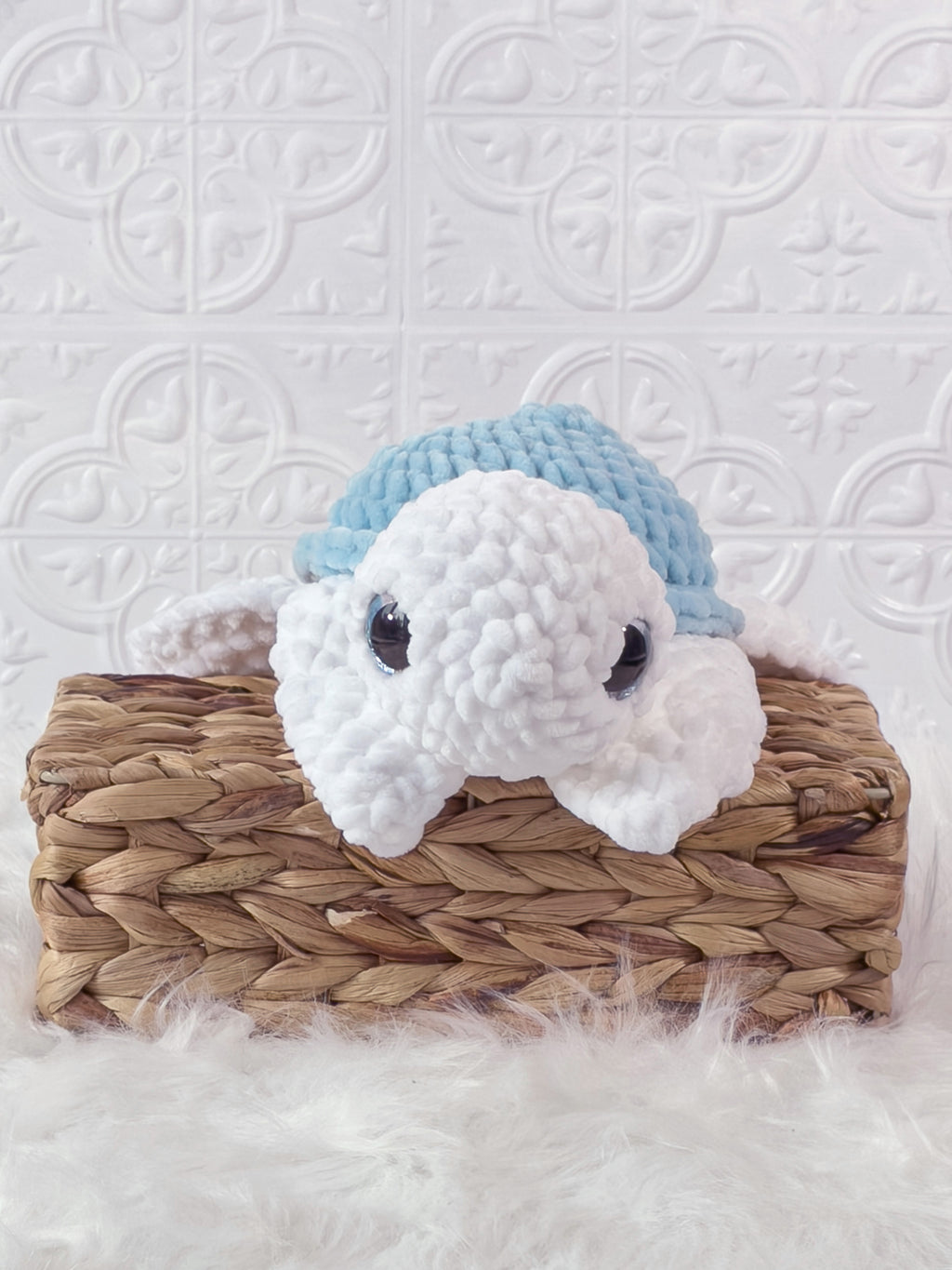 Handmade blue turtle crochet plushie shown from the front