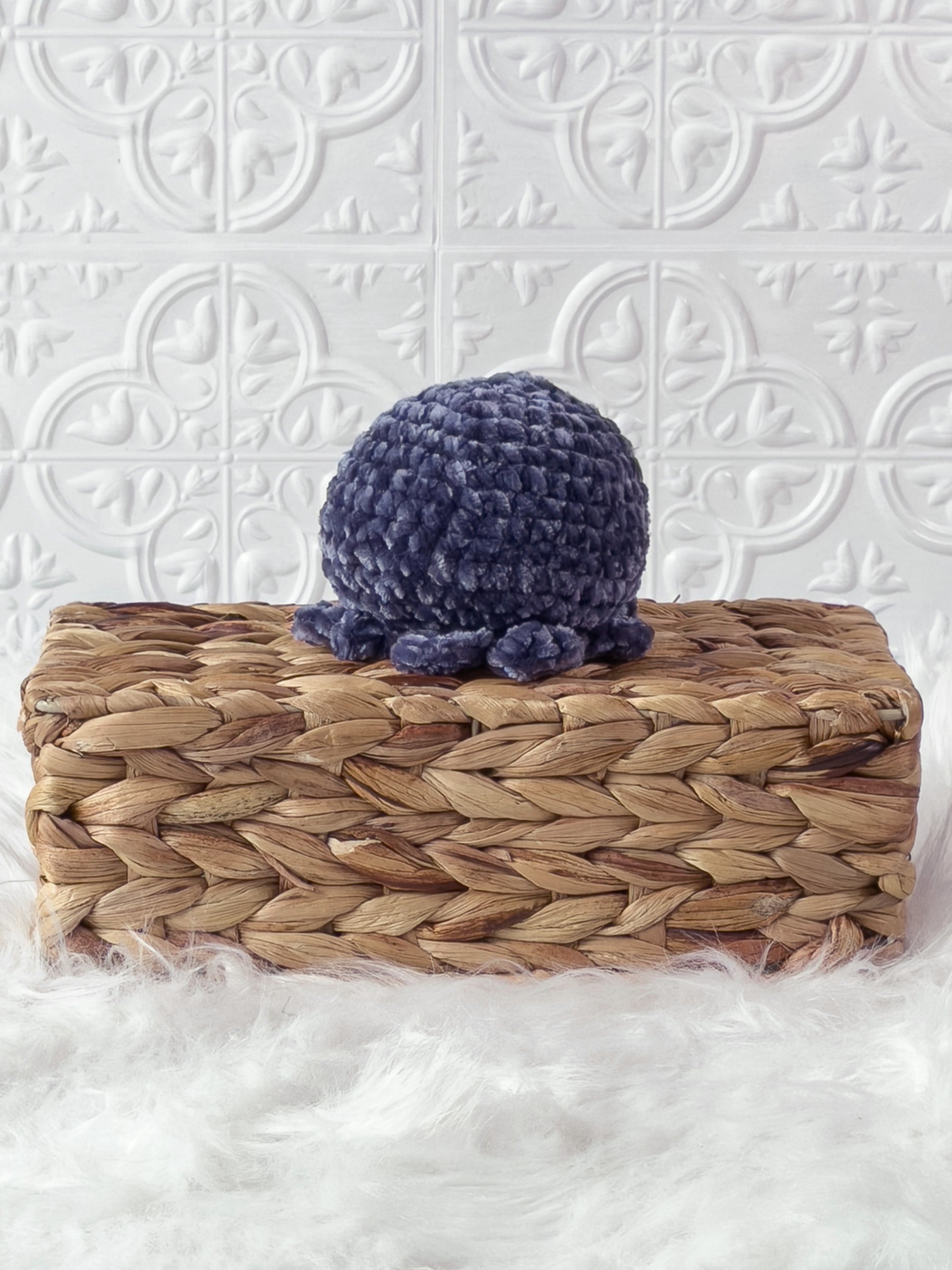 Handmade blue, dark octopus crochet plushie shown from the back