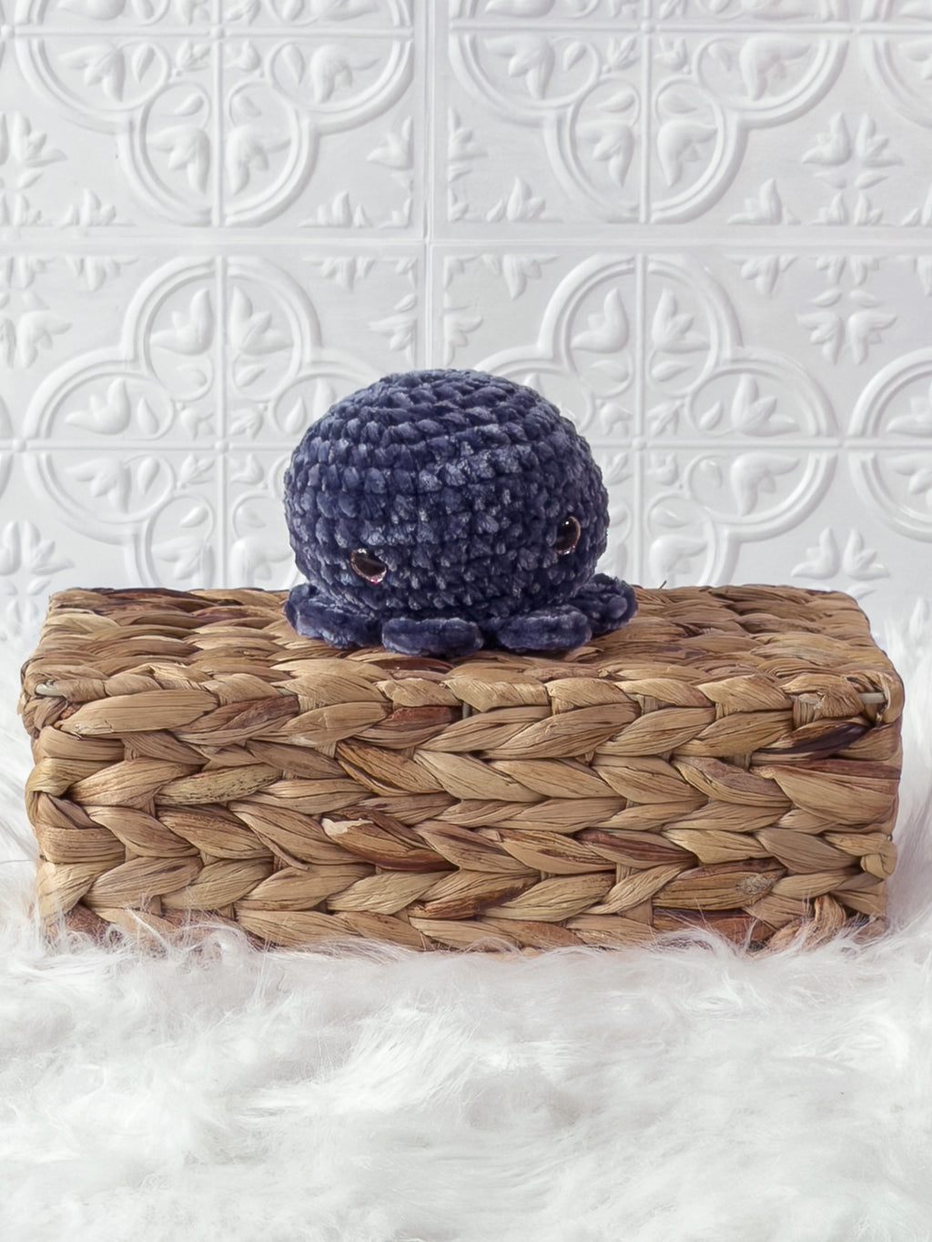 Handmade blue, dark octopus crochet plushie shown from the front