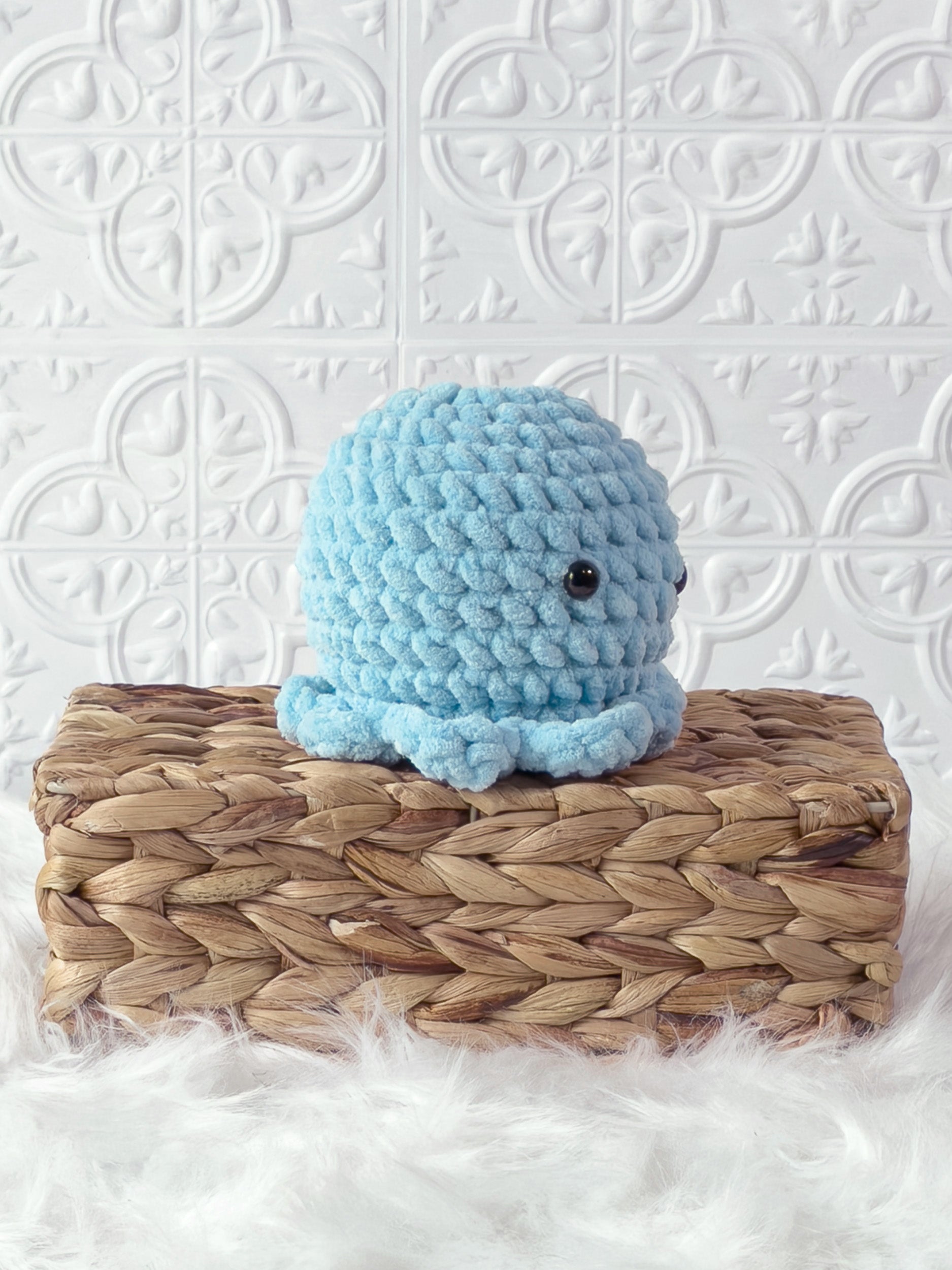 Handmade blue octopus crochet plushie shown from an angled view