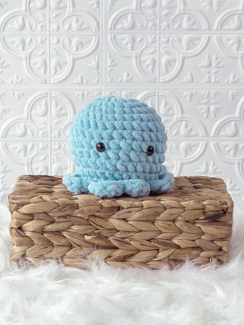 Handmade blue octopus crochet plushie shown from the front