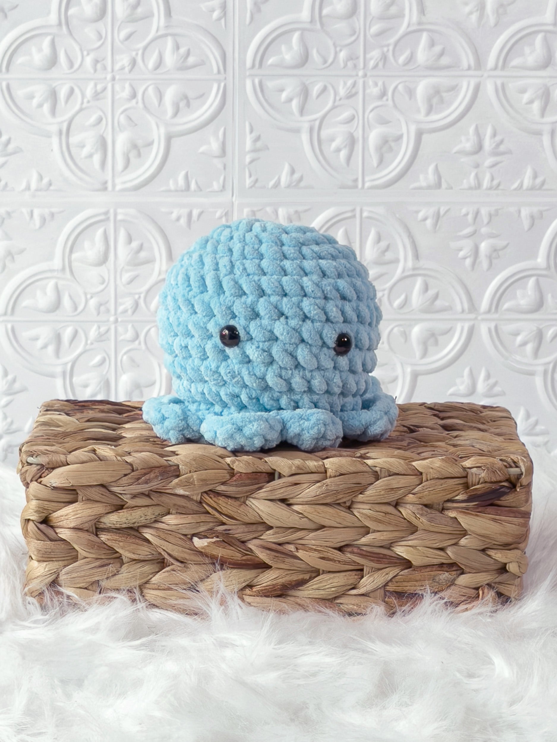 Handmade blue octopus crochet plushie shown from the front
