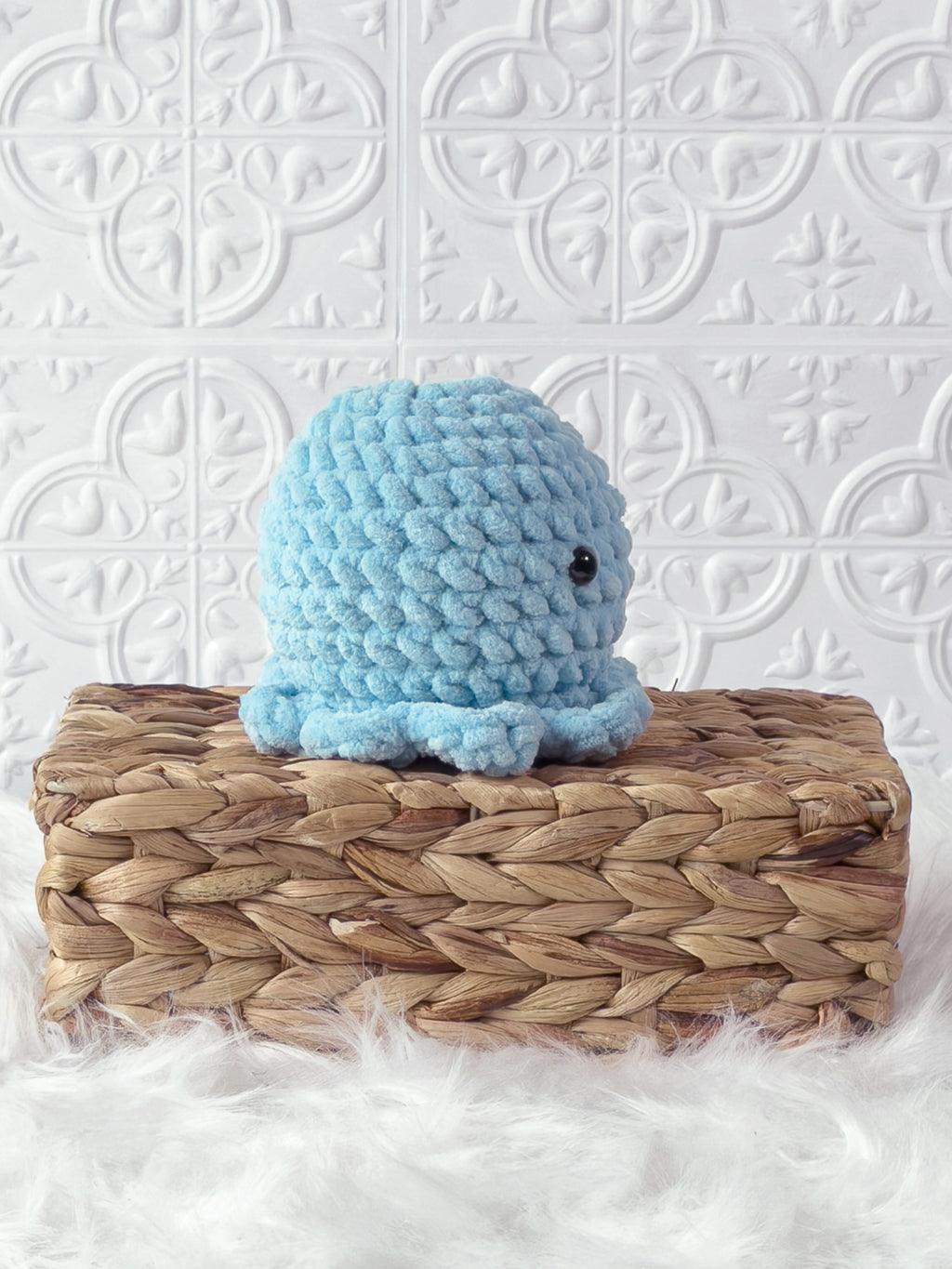 Handmade blue octopus crochet plushie shown from the side