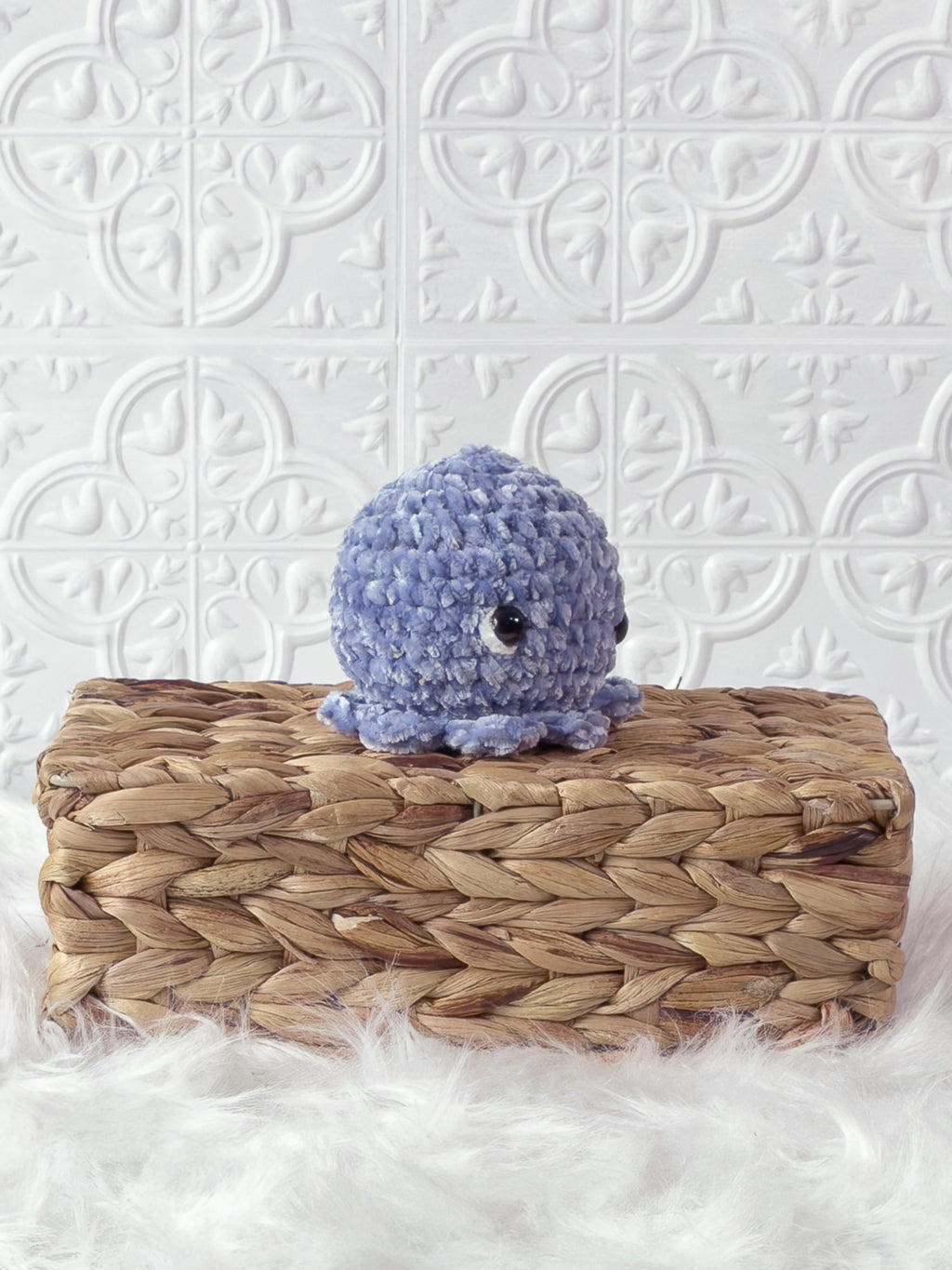 Handmade blue, light octopus crochet plushie shown from an angled view