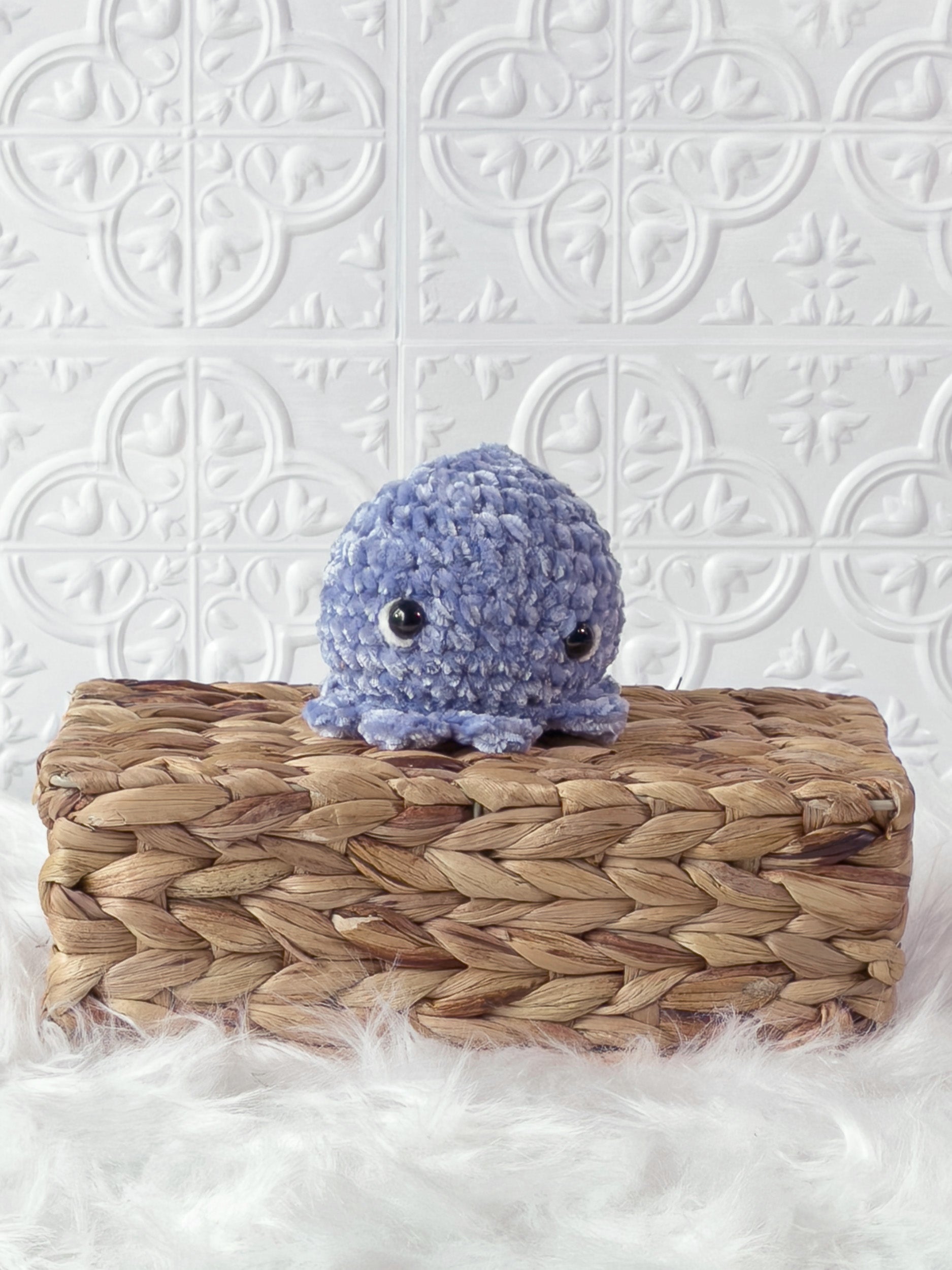 Handmade blue, light octopus crochet plushie shown from the front