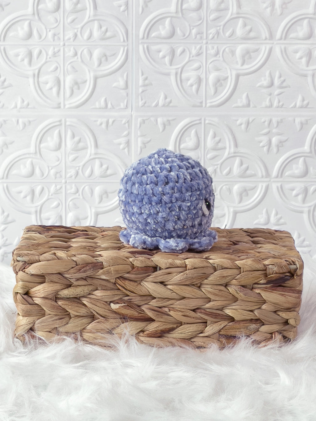 Handmade blue, light octopus crochet plushie shown from the side