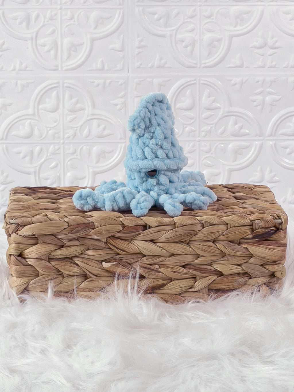 Handmade blue, light squid crochet plushie shown from an angled view