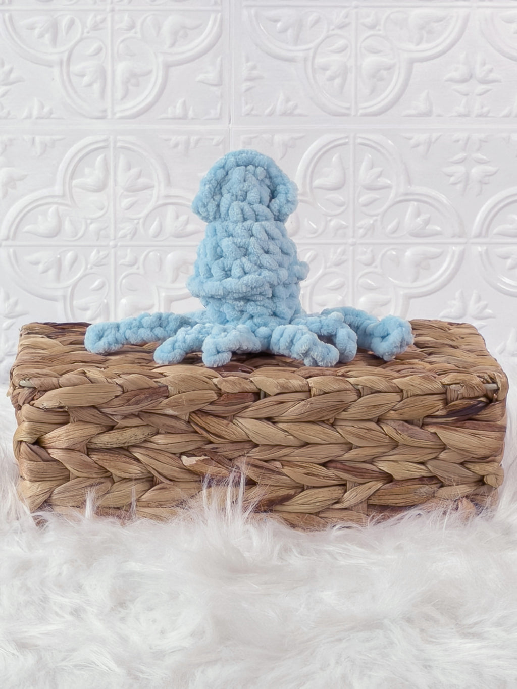 Handmade blue, light squid crochet plushie shown from the back