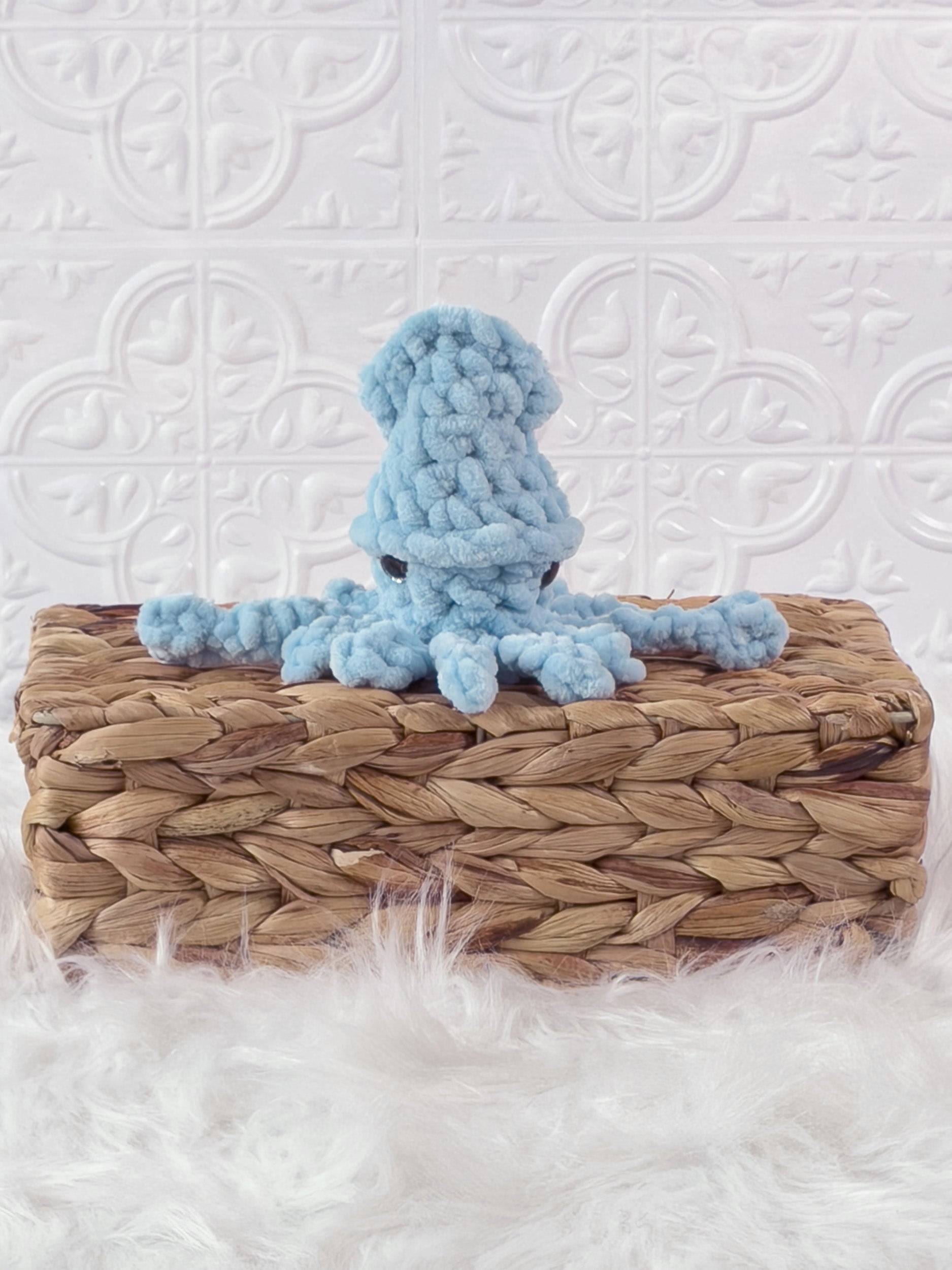 Handmade blue, light squid crochet plushie shown from the front