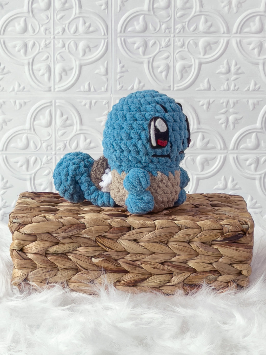 Handmade blue, light squirtle crochet plushie shown from an angled view